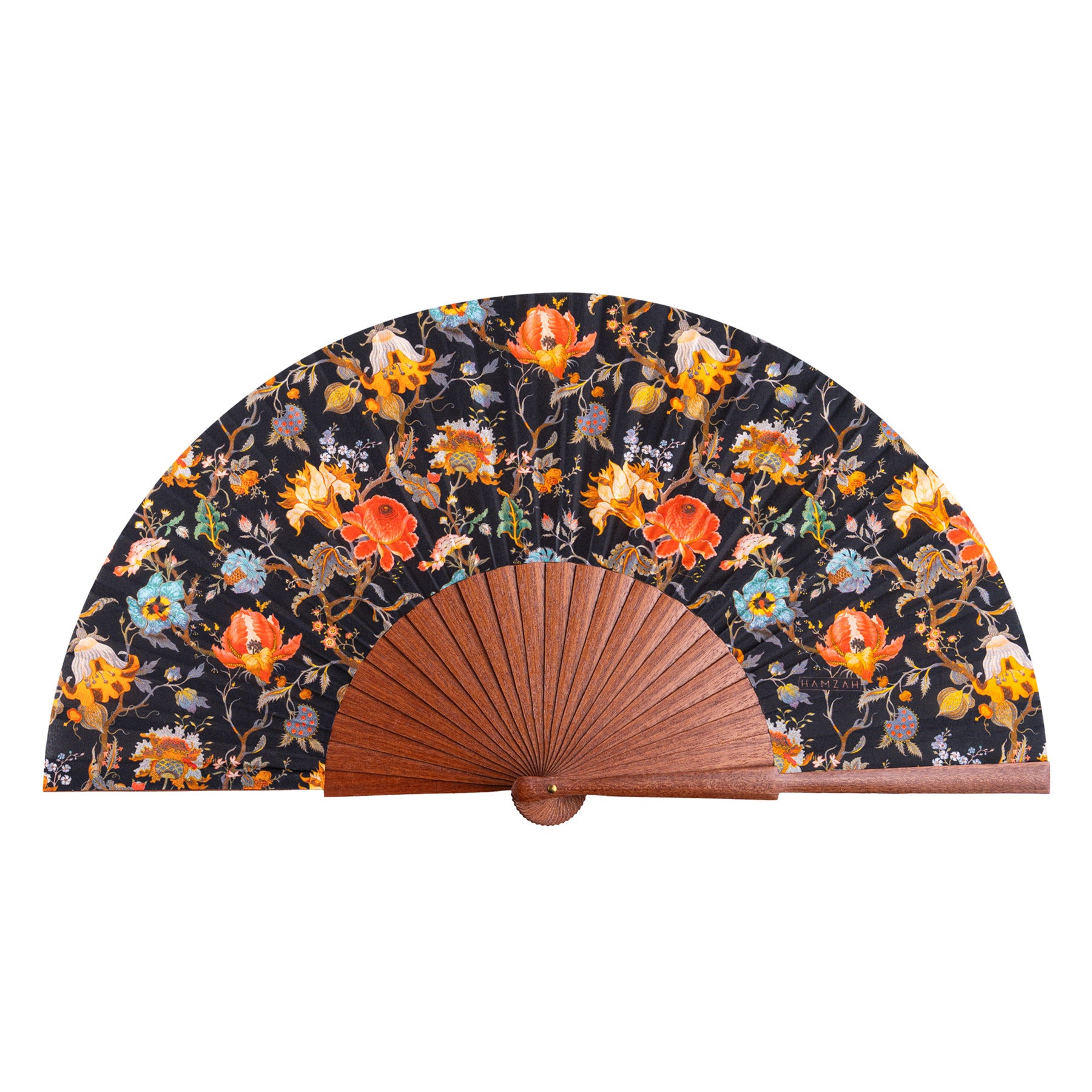 The William Morris Print Hand Fan Aubrey features a colorful floral pattern in orange, yellow, and purple on silk, set against a dark background. Fine Spanish craftsmanship and elegant wooden ribs complete this stylish handheld accessory.