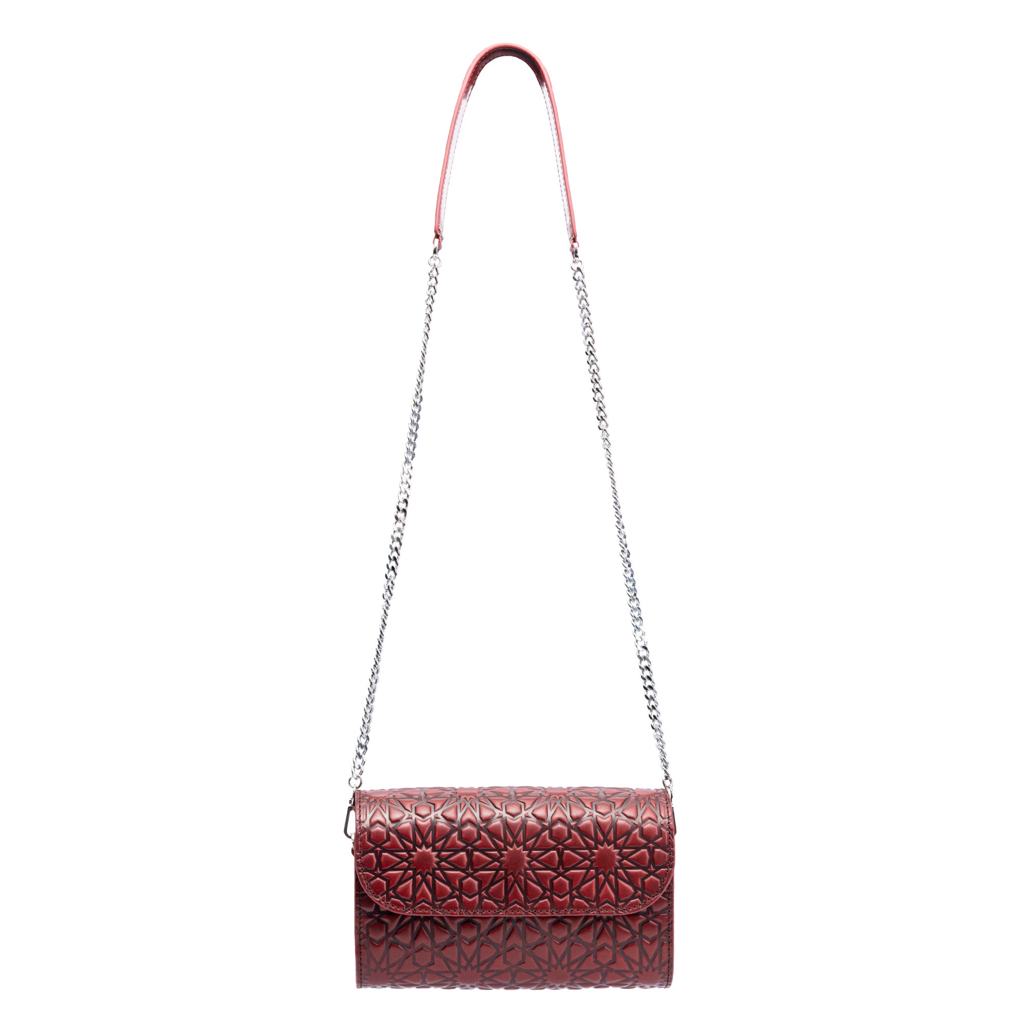 The Small Burgundy Leather Bag Bayarcal is a handmade shoulder bag crafted from vegetable-tanned leather with Islamic-inspired embossing, a silver chain strap, and flap closure, shown against a white background.