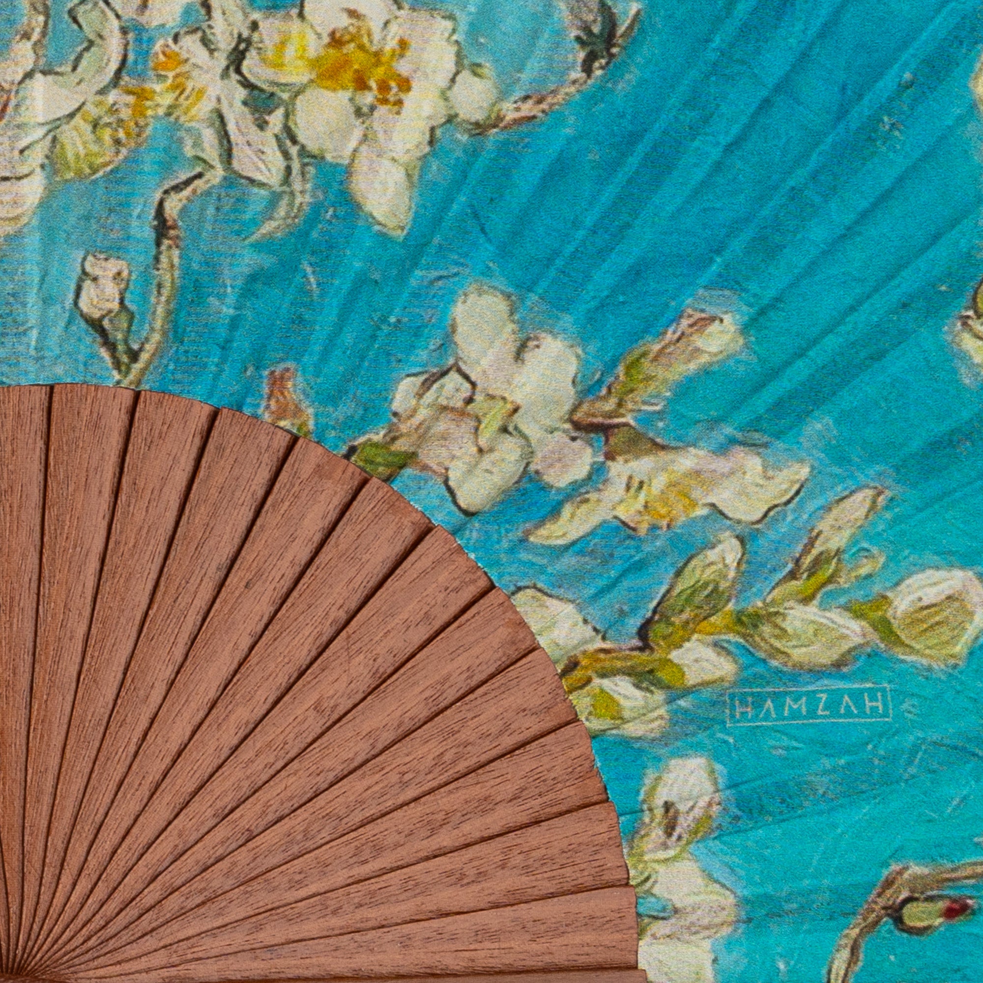 Close-up of the Van Gogh Print Hand Fan Delphine showing the Van Gogh Almond Blossom print on light blue in detail.