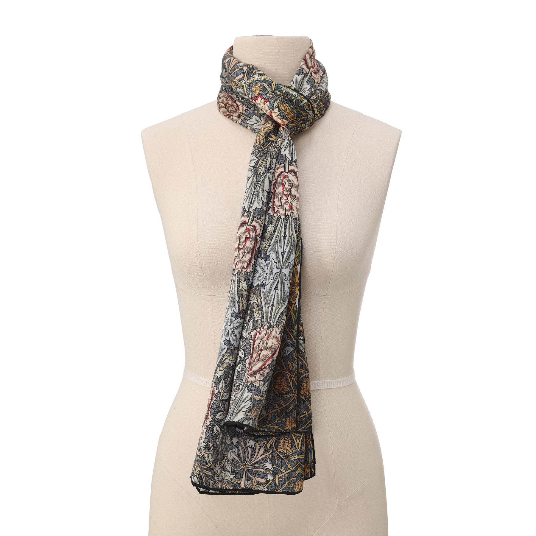 The Grey Silk Scarf Erna features an intricate, symmetrical floral pattern in blue, pink, green, and gold with repeating motifs and a dense woven texture reminiscent of vintage art nouveau design.