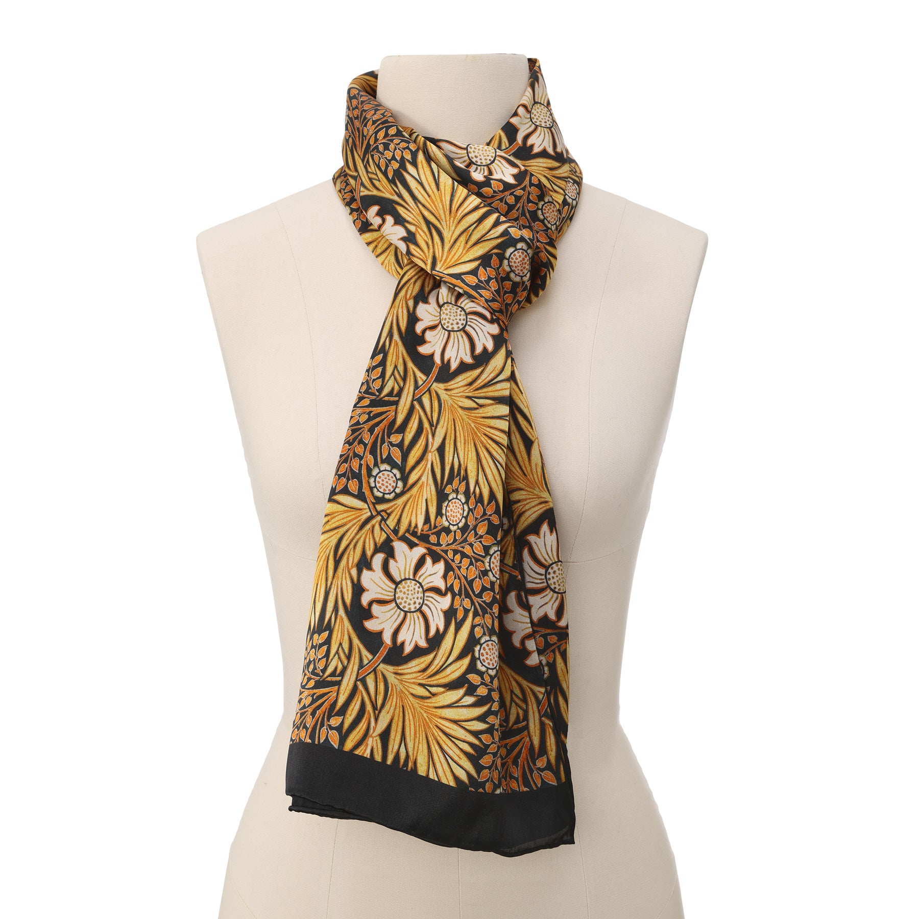 Close-up of the Black Silk Scarf with Gold Floral Motifs Aurum, softly folded to showcase intricate floral patterns in gold, yellow, orange, and white on a black satin silk background.