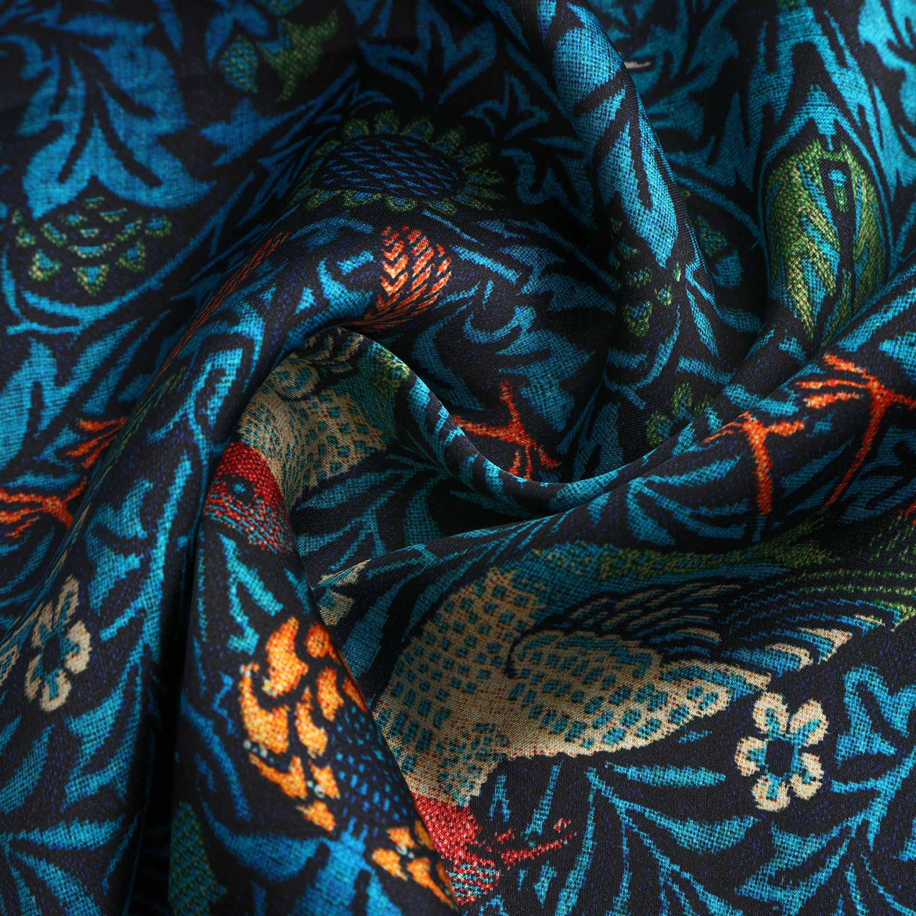A close-up of the William Morris Inspired Silk Scarf showcases vibrant blue fabric adorned with intricate bird and floral