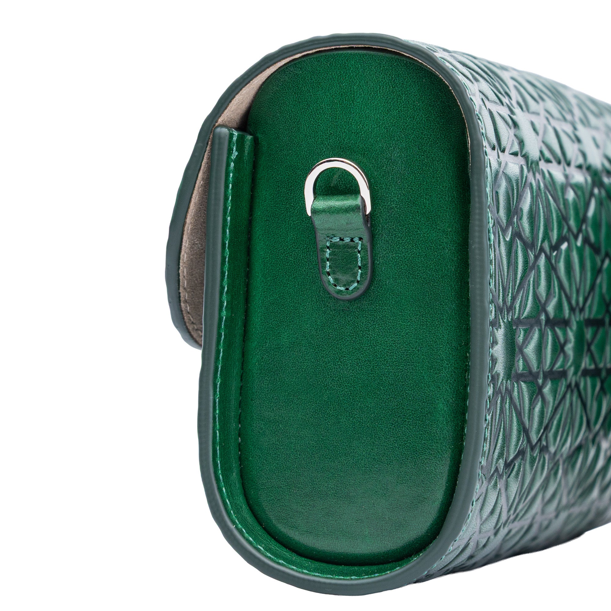 Close-up of the Bayarcal Small Embossed Leather Bag in dark green, handcrafted in Spain with eco-friendly leather, Islamic geometric embossing, a silver D-ring on the side, and visible stitching details.