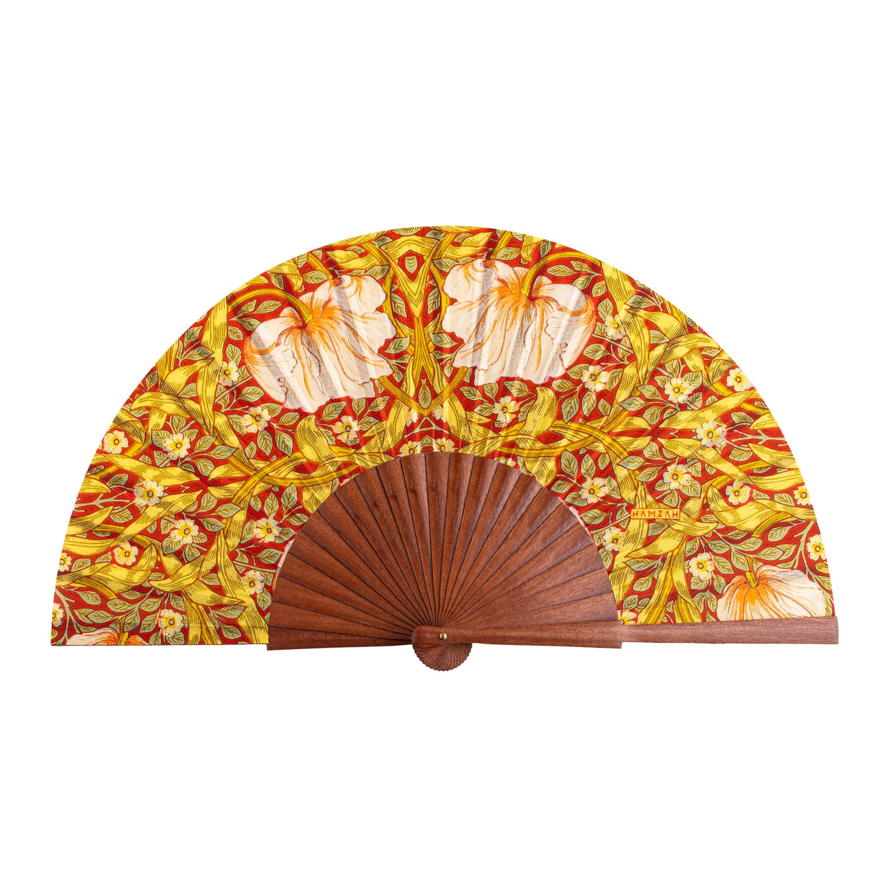 The Hand Fan Made in Spain Basile features a wooden base and vibrant fabric with yellow, orange, and red floral patterns, accented by white flowers and swirling leaves.