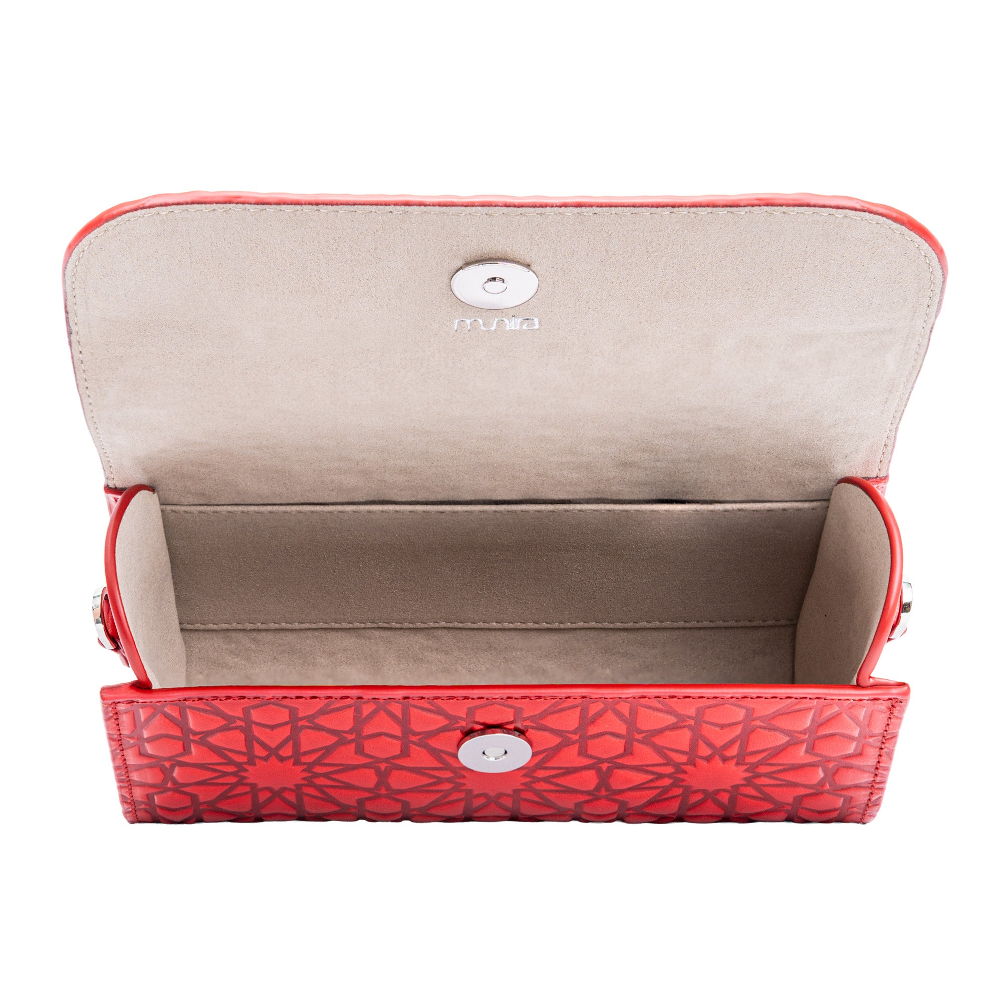 The Small Leather Hand Bag Red - Bayarcal is a handmade leather clutch with geometric embossing, a magnetic snap closure, and a spacious beige interior that highlights vegetable-tanned leather craftsmanship.