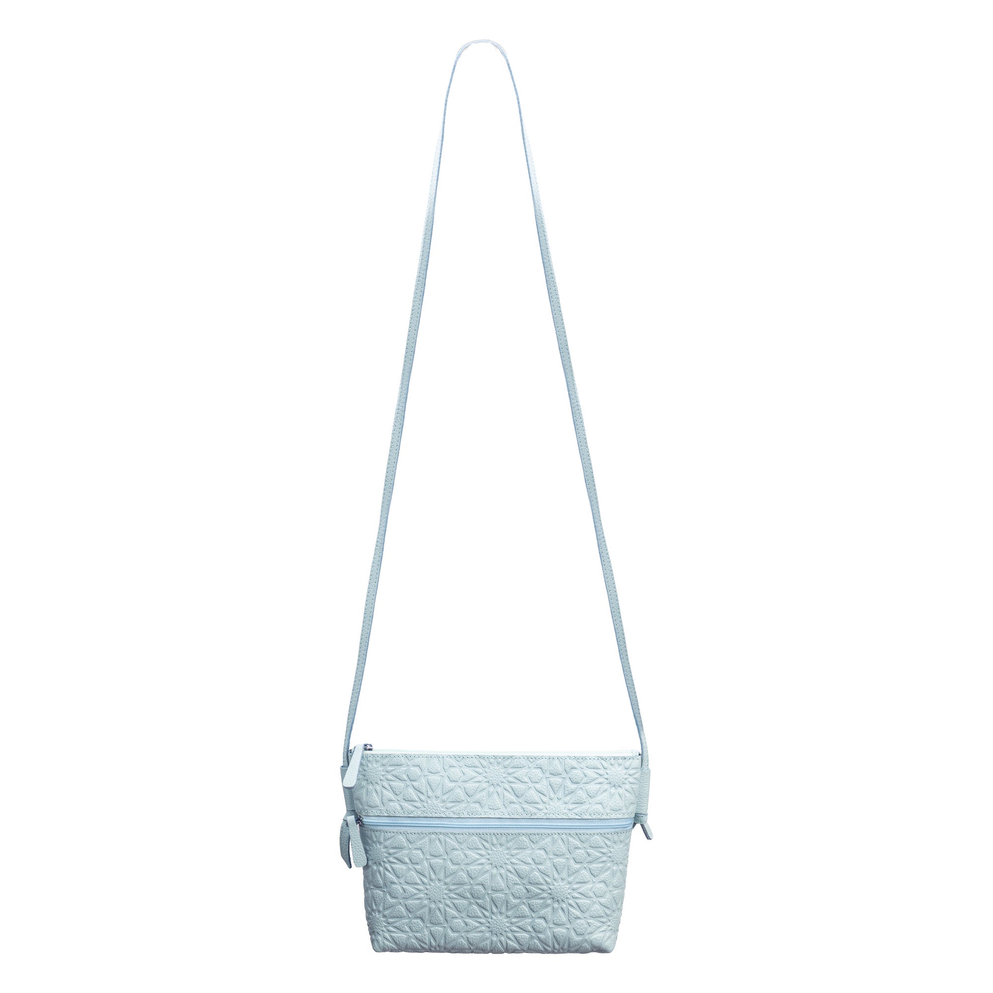 A light blue embossed crossbody bag with an Islamic design pattern, featuring a long adjustable strap and top zipper closure, is displayed against a white background.
