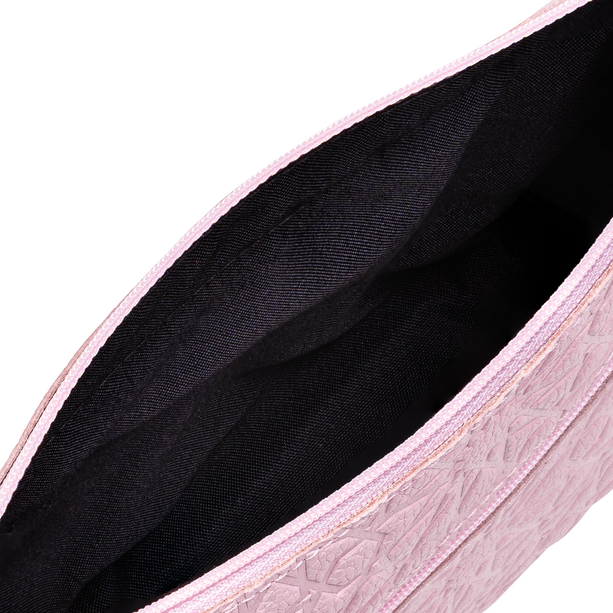 Close-up of the open interior of the Pale Pink Embossed Crossbody Bag with Islamic Design Pattern, featuring a black lining, inner pocket, and textured exterior details.