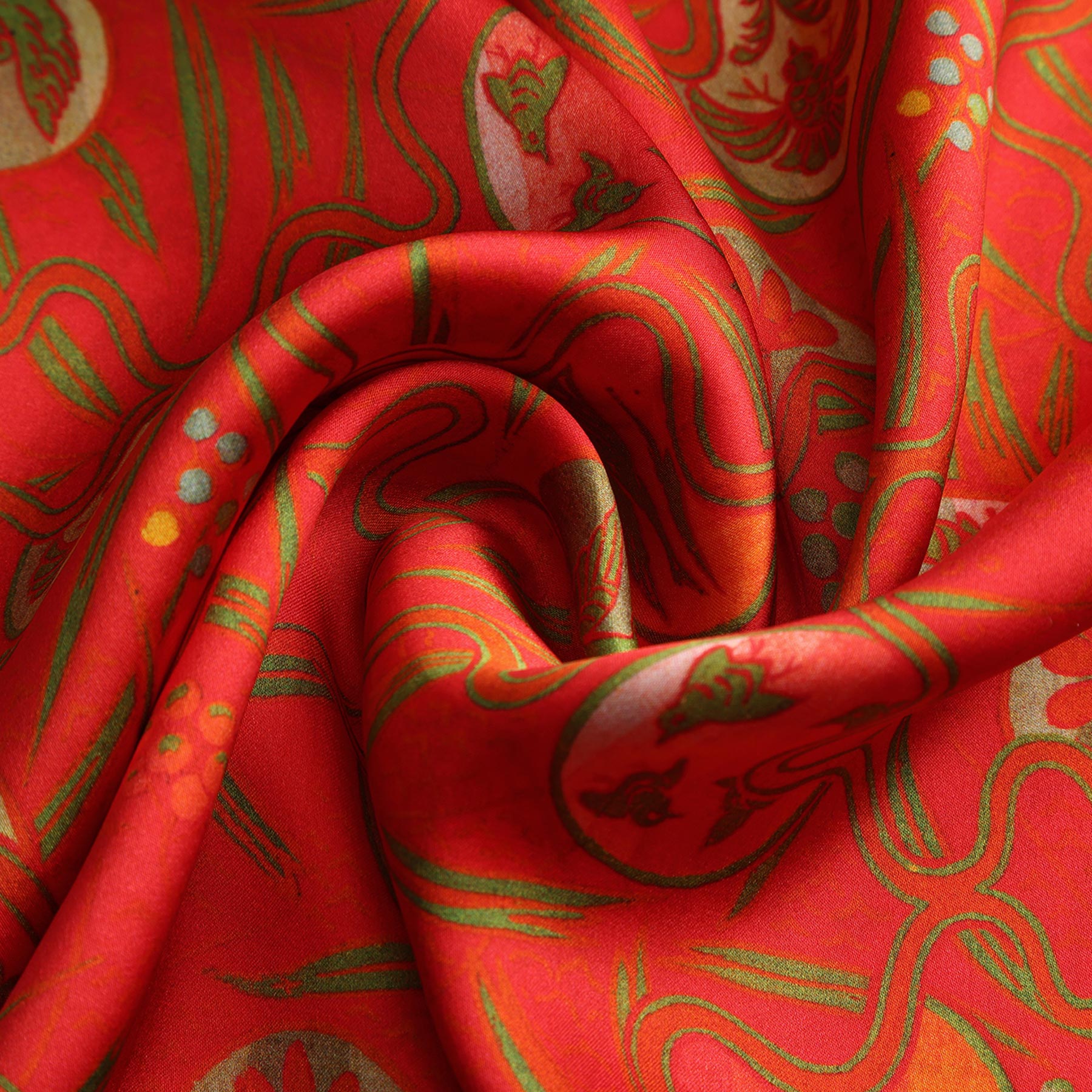 A rectangular red silk scarf featuring an abstract floral print in a Kabuki art style, accented with dark blue borders on the short ends.