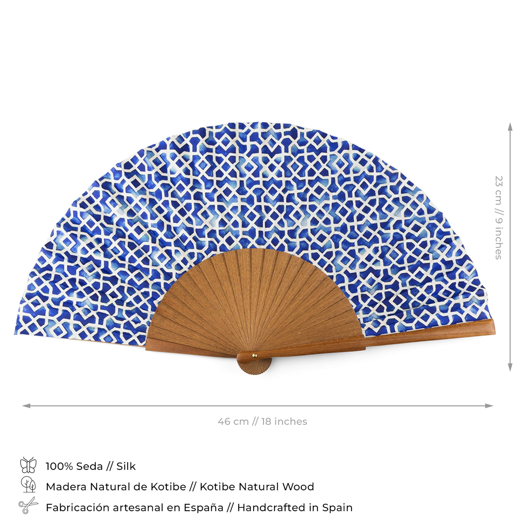 The Folding hand fan Alcazaba blue features a blue and white patterned premium silk and a natural bocapi wood base, measuring 46 cm wide by 23 cm tall. Handcrafted in Spain from high-quality silk and wood.