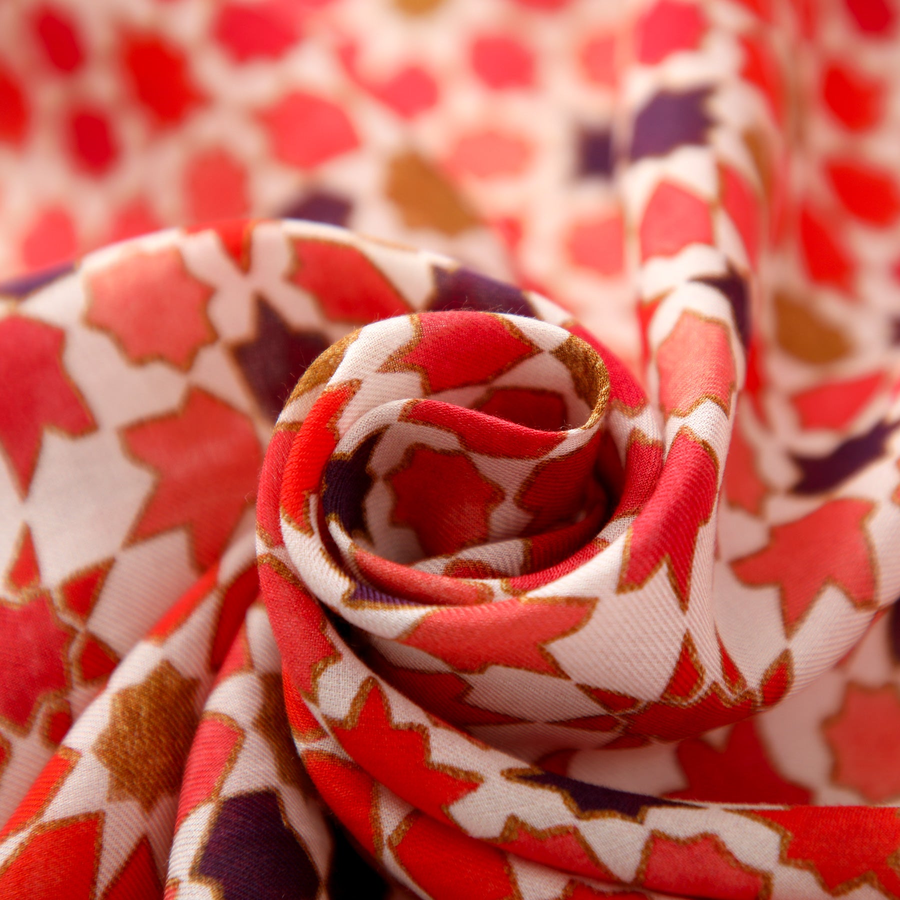 A close-up of the Modal Hijab with Islamic Design Red - Alhambra, featuring soft, smooth fabric with a vibrant geometric