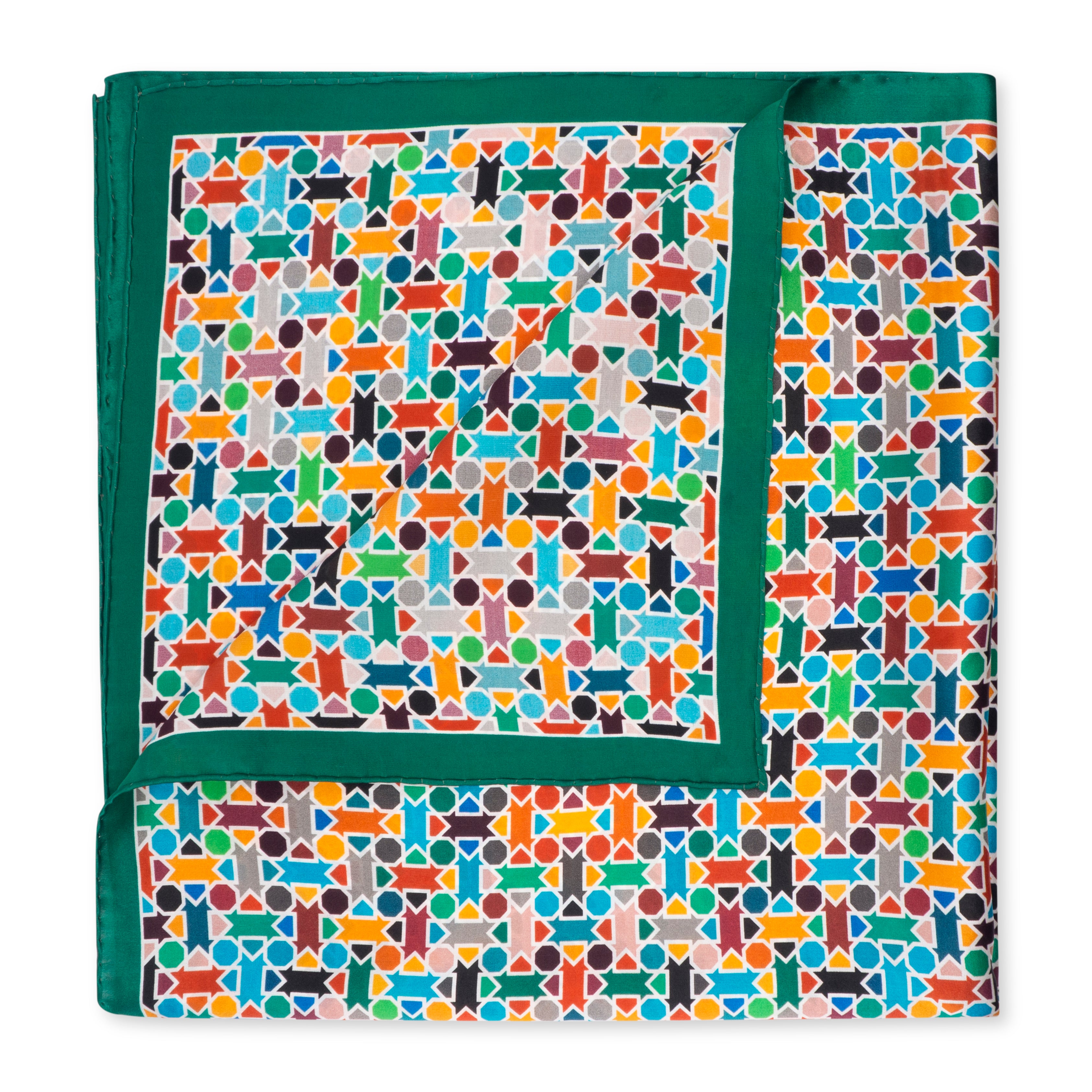 The Multicolor Silk Square Scarf Amal showcases a vibrant geometric pattern in blue, orange, red, yellow, and green with a solid green border. Partially folded, it displays both sides and features elegant hand-rolled hems.