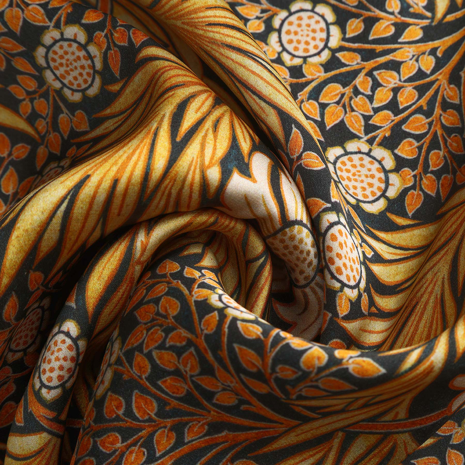 A black box with HAMZAH at the top, a window revealing the Black Silk Scarf with Gold Floral Motifs Aurum inside, and “Wrap yourself in elegance” printed at the bottom.