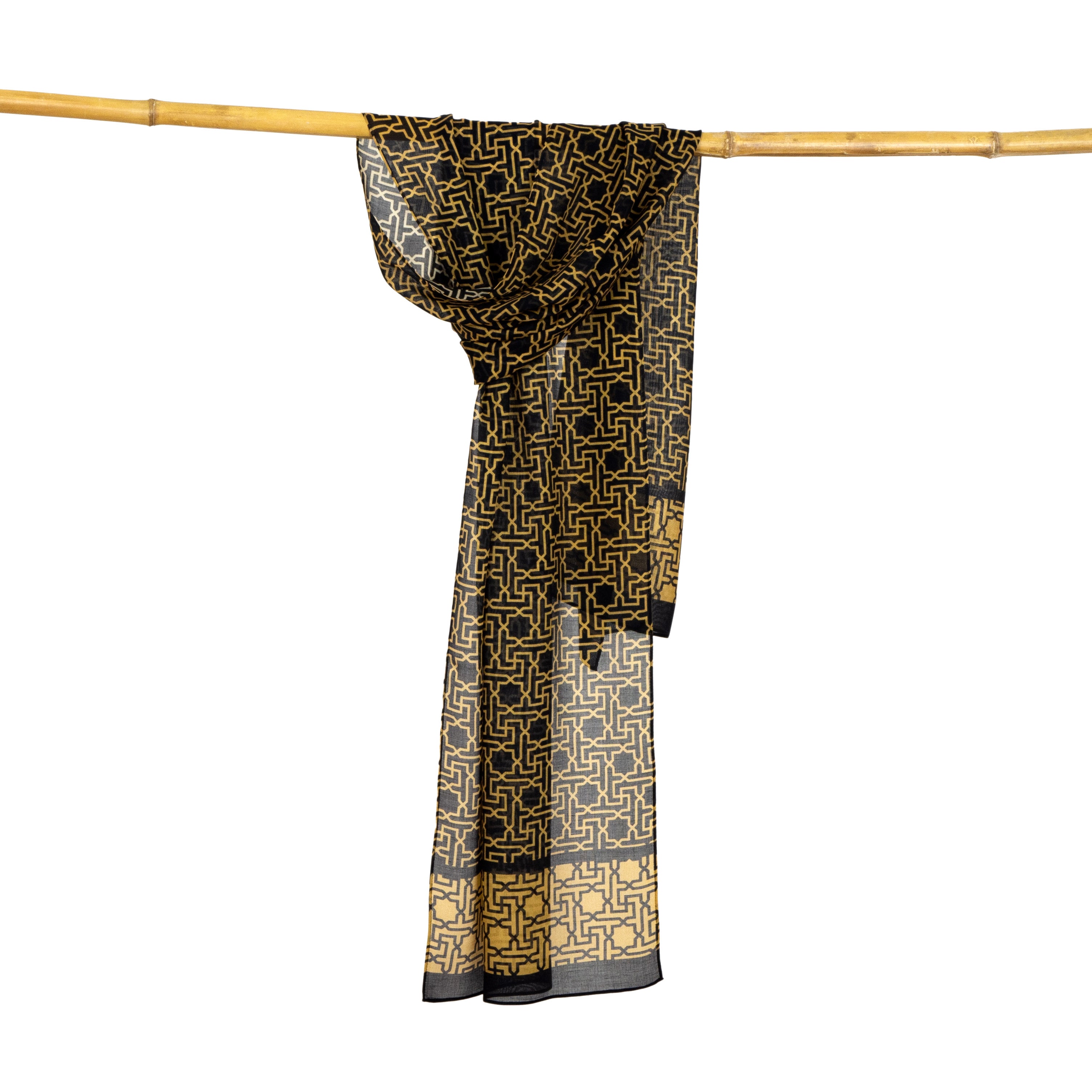 The Black and Gold Scarf Rawda v3, featuring Alhambra-inspired motifs and geometric design, is draped over a horizontal bamboo pole against a plain white background.