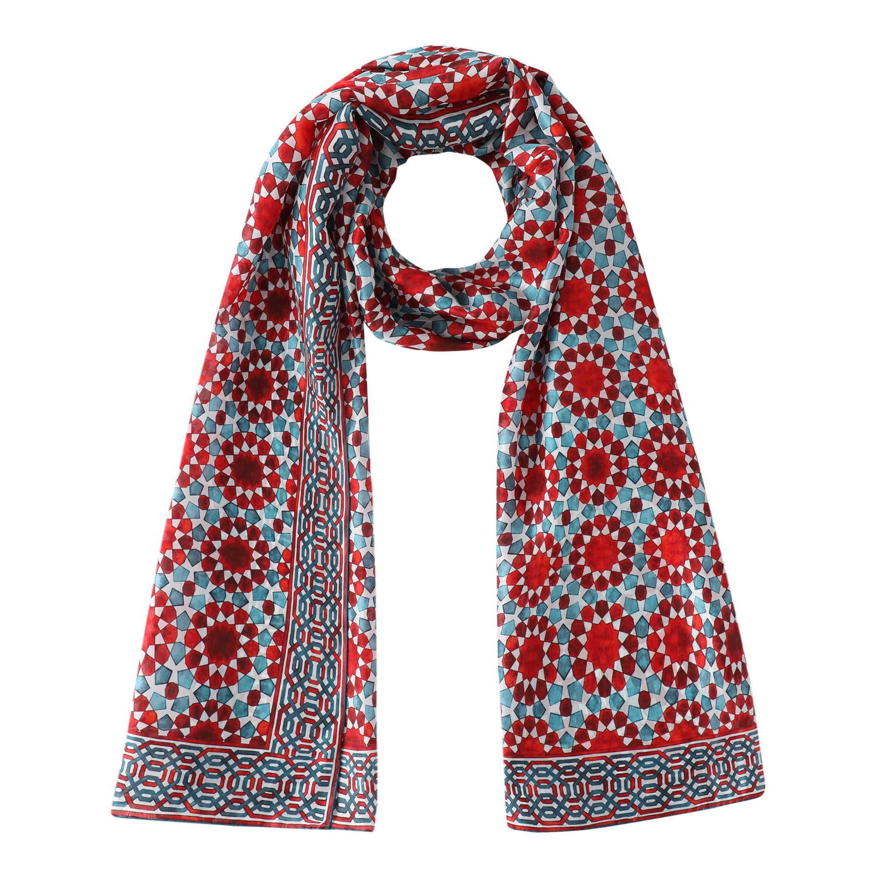 The Red and Blue Large Silk Scarf Najma features a geometric mosaic-inspired Islamic pattern in red, blue, and white. Draped in a loop with hanging ends, it brings an elegant accent to any outfit.