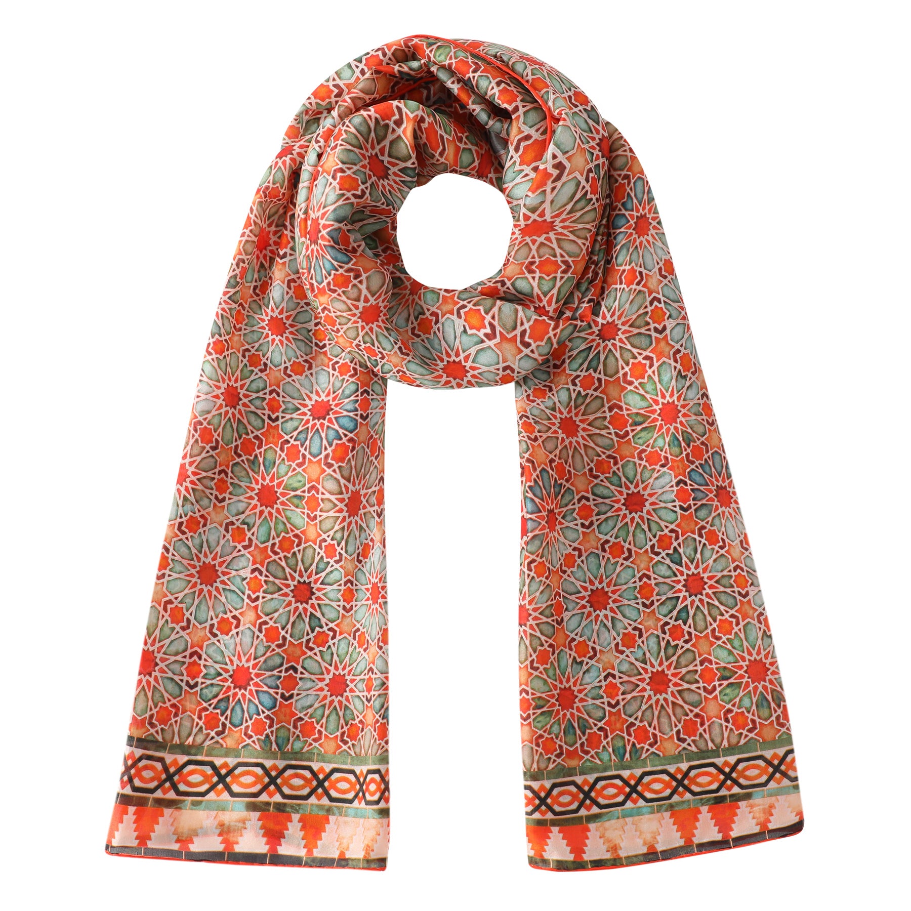 The Orange Silk Scarf with Geometric Print Zellige features an intricate geometric floral pattern in red, green, and orange tones with a decorative border, inspired by mosaic tiles. The scarf is neatly rolled at the top and laid flat.