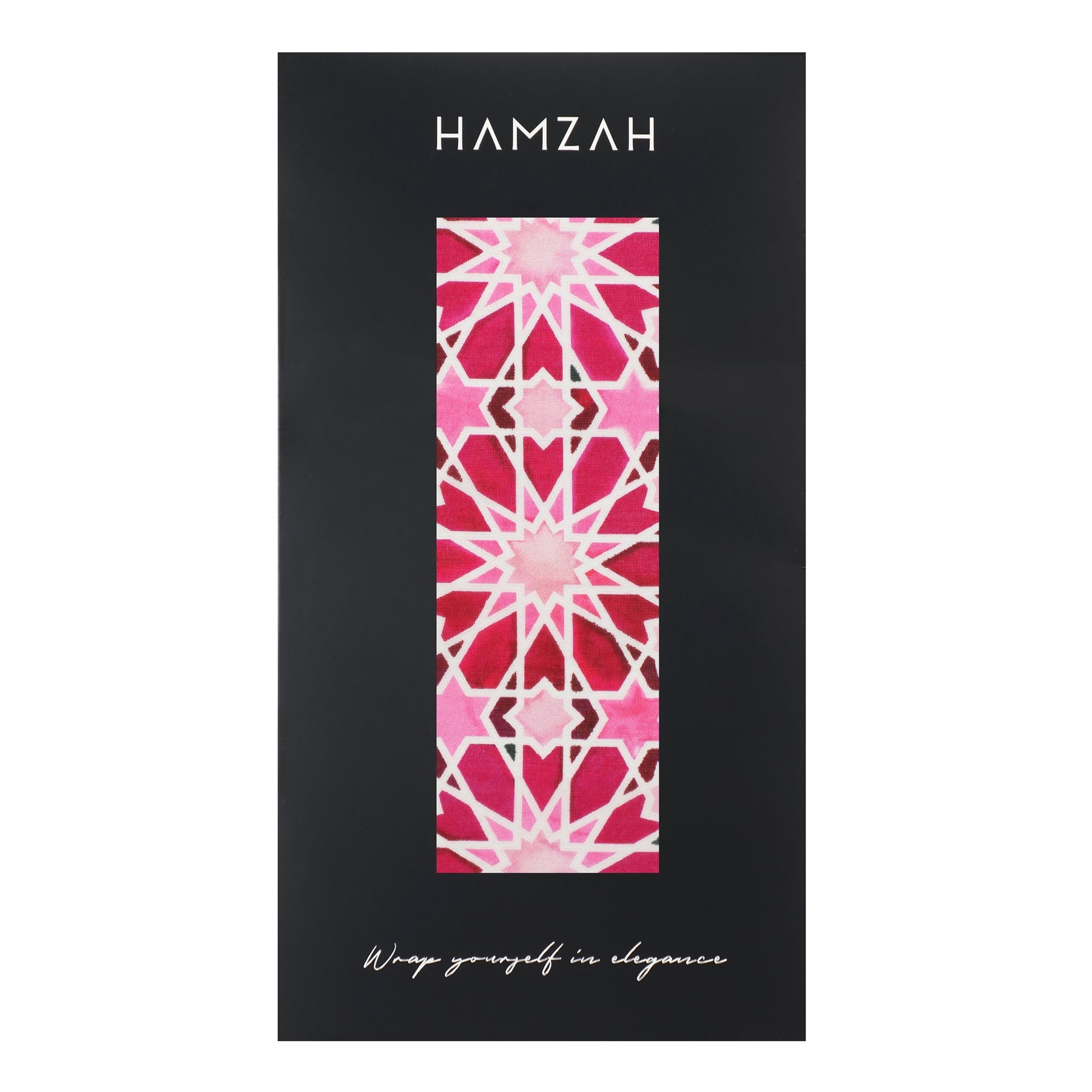 A Large Pink Silk Scarf with Zelig Print in bold red and white is shown vertically on black HAMZAH packaging. “Wrap yourself in elegance” appears at the bottom.