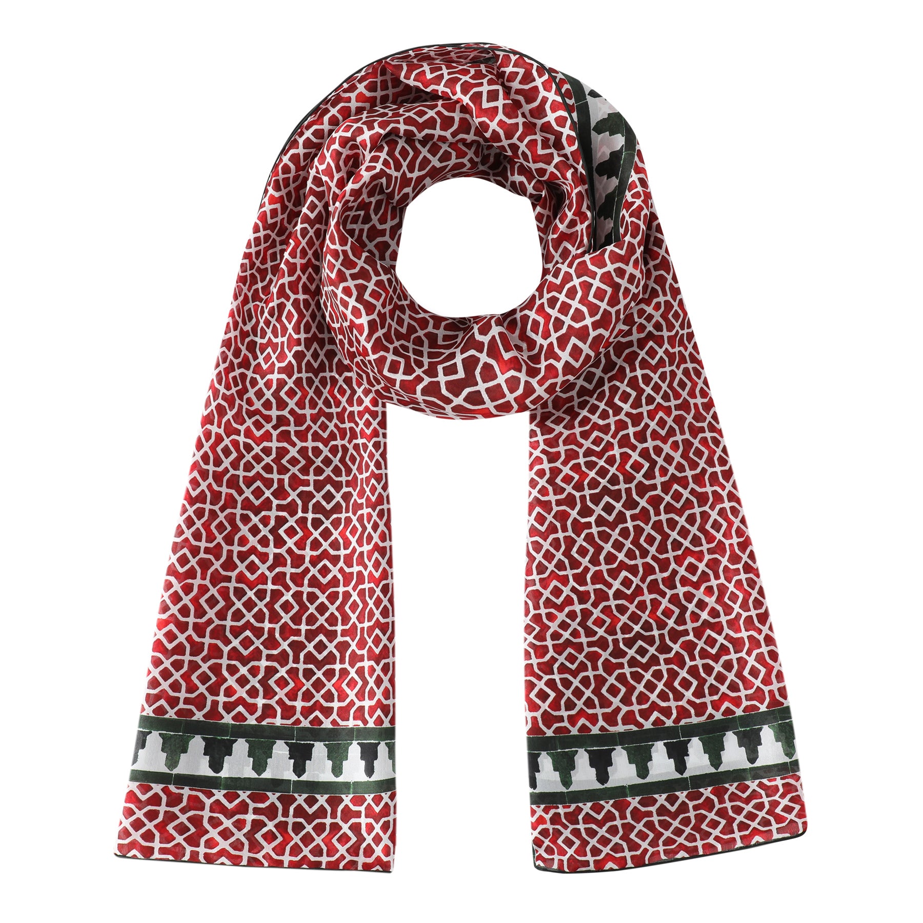 The Red and Green Silk Scarf Alcazaba features a Moroccan tiles pattern, black and white border near the ends, and is shown laid flat with one end looped in a circle.
