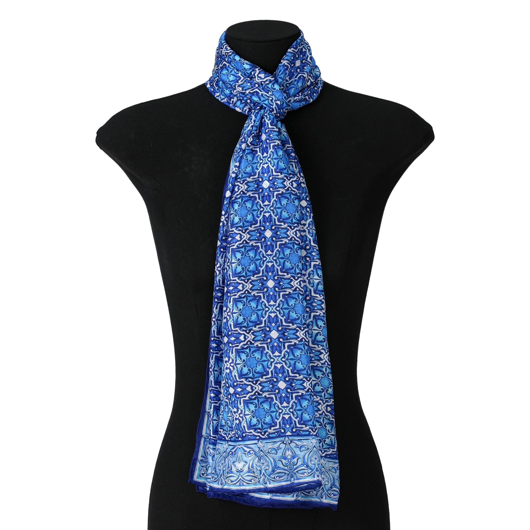 A black mannequin showcases the Blue Silk Scarf with Geometric Print Farah, tied elegantly around the neck—the perfect statement accessory to enhance any look.
