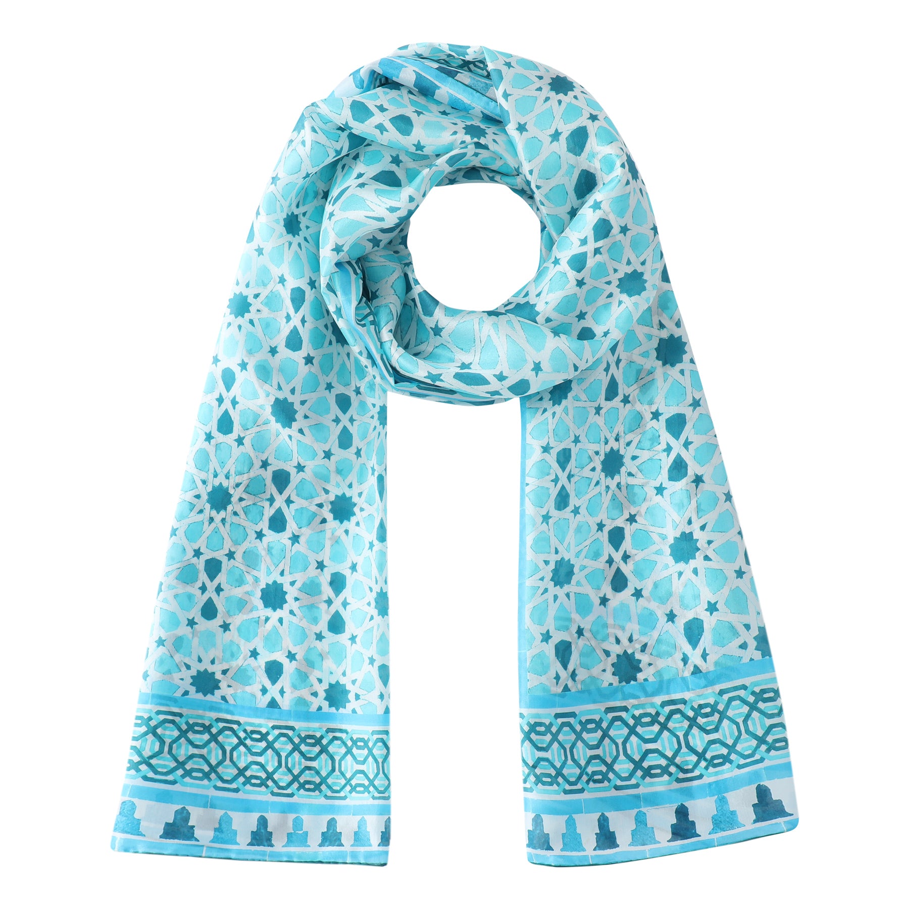 The Light Blue Silk Scarf Partal features intricate white geometric and floral patterns inspired by Islamic mosaic art, with decorative borders along the short edges. Shown looped with both ends draping down.