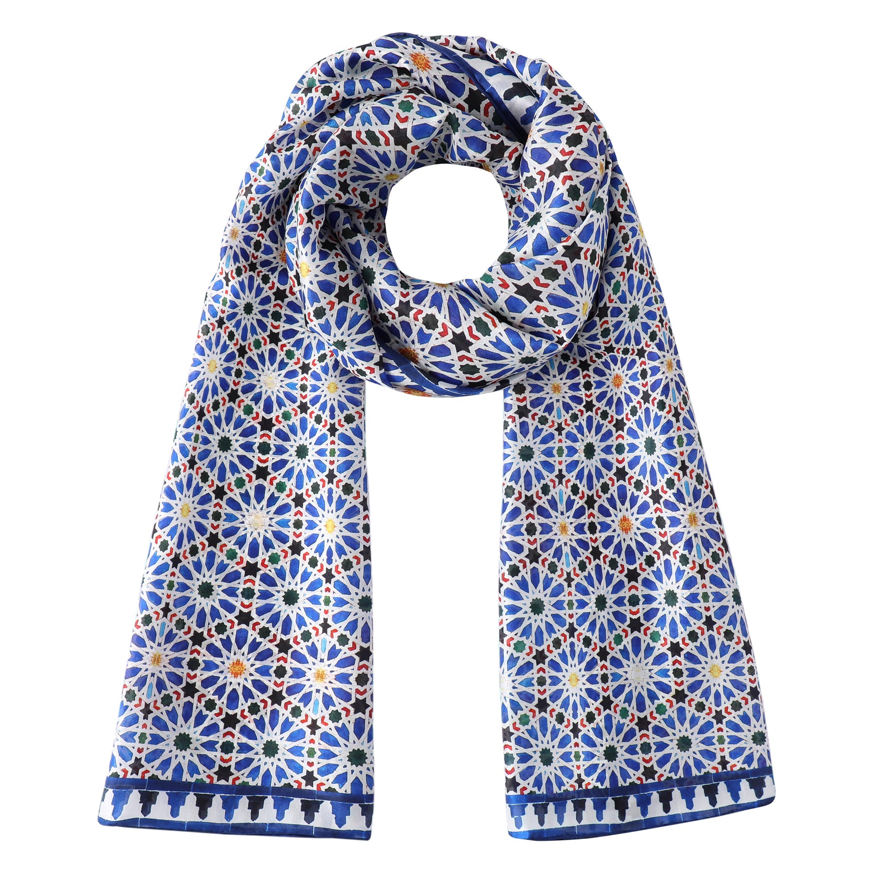 The Hamzah Islamic Art inspired Silk Scarf Zellige features a colorful geometric floral pattern in blue, white, orange, and green with a dark blue border. The long silk scarf is looped with both ends draped down.