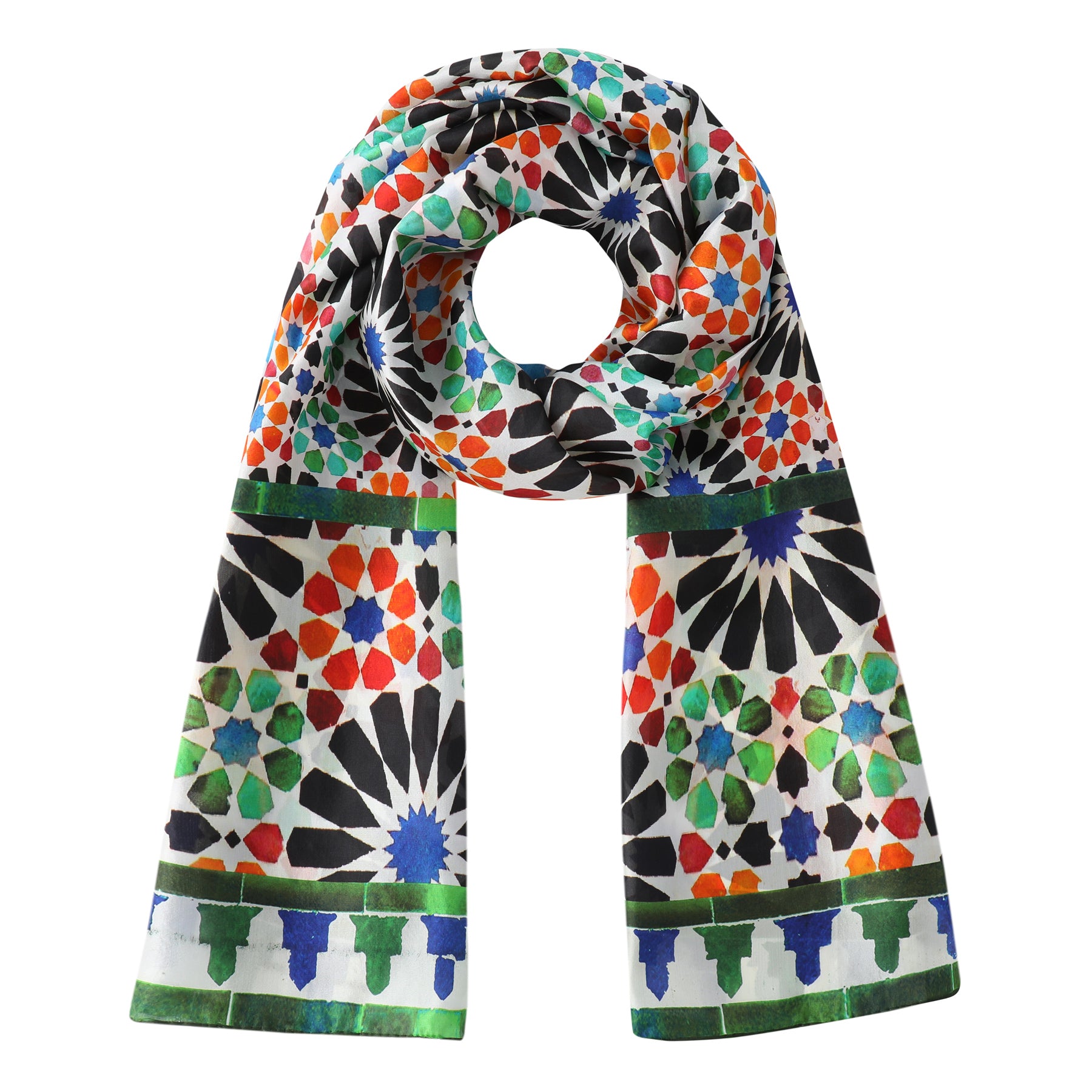 Add a dash of colour with the Green and Orange Silk Scarf Garnata, crafted from fine silk and showcasing bold geometric patterns in black, green, red, blue, and orange mosaics on a crisp white background.