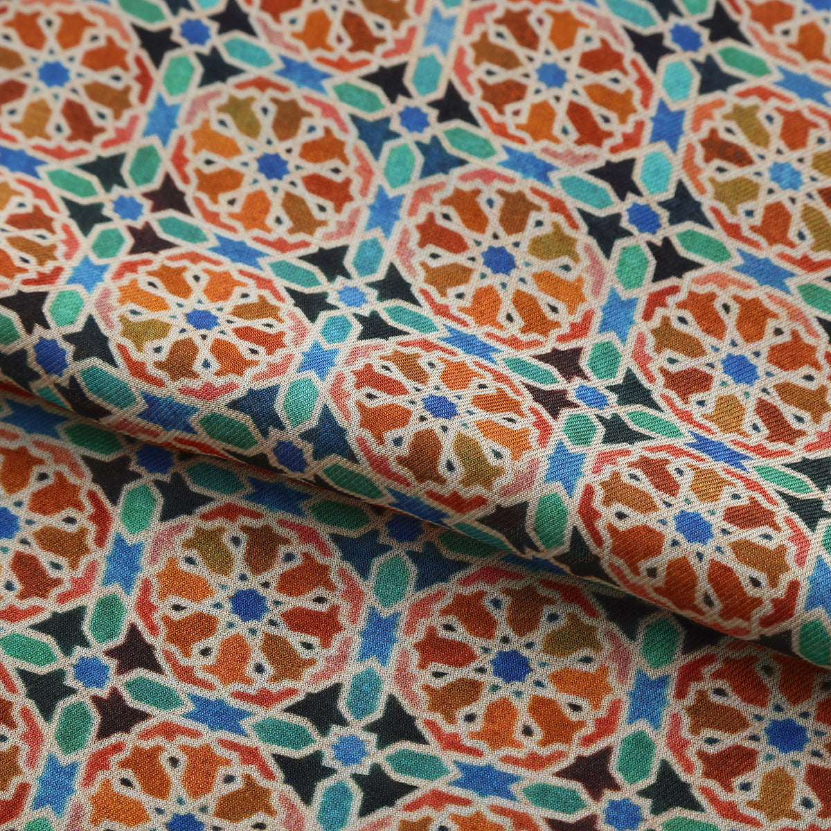 Folded fabric detail of the Orange Modal Scarf Mosaic Wheels Wallada, showing the orange wheels and turquoise fill on black