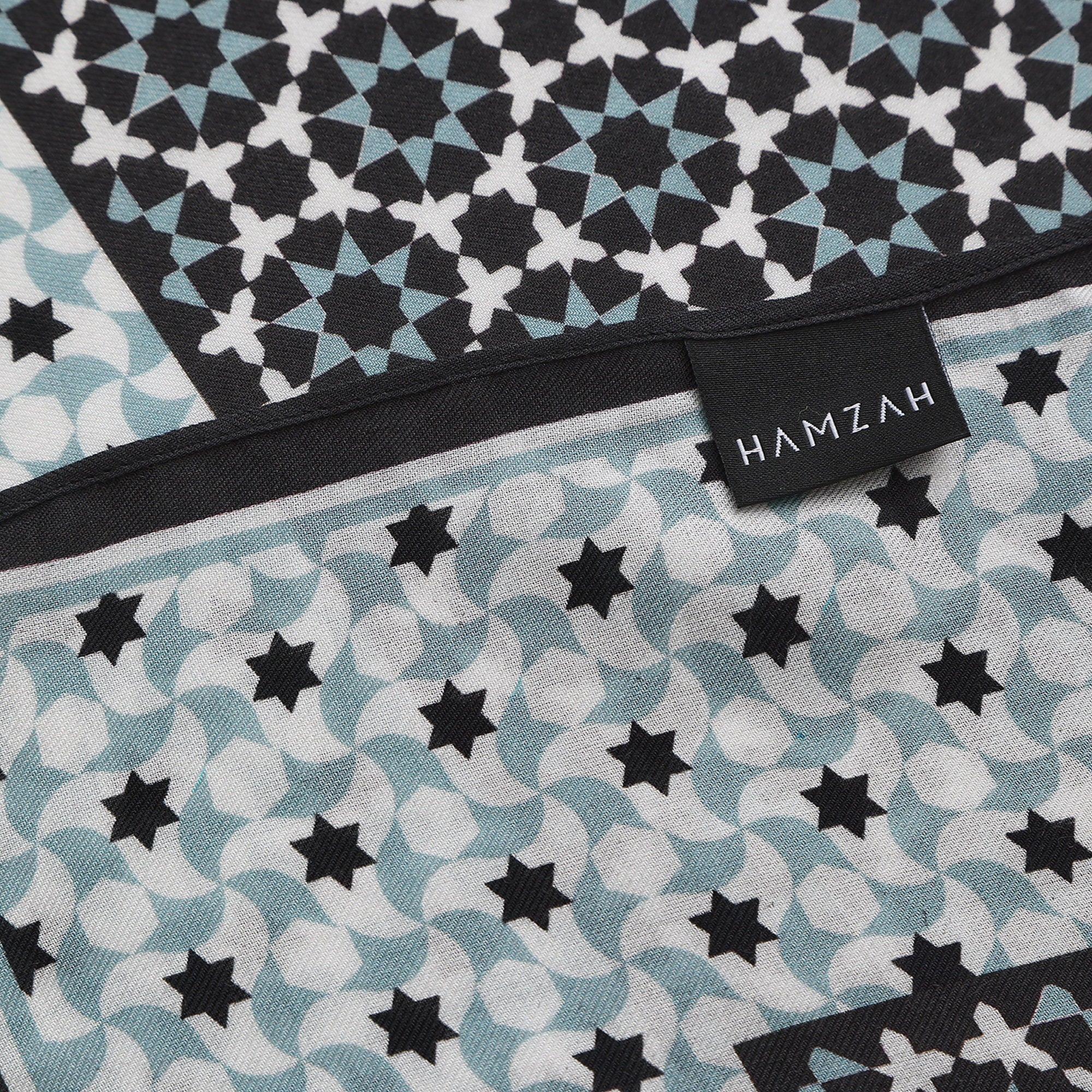 Corner of the Black and Grey Modal Scarf Star Lattice Zoraida with the Hamzah woven label