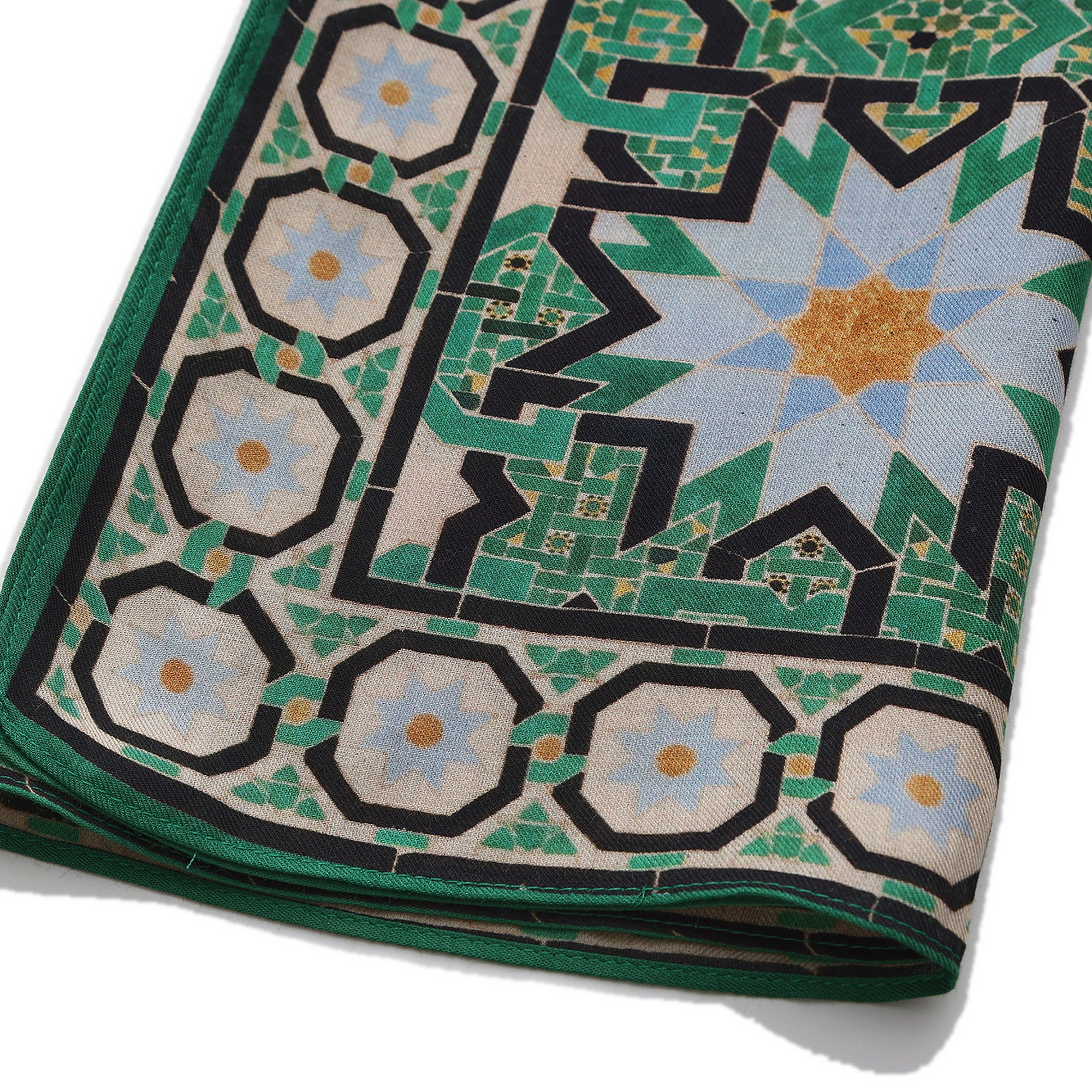 Folded corner of the Green Modal Scarf Alhambra Interlace Salma, showing the border and the hem