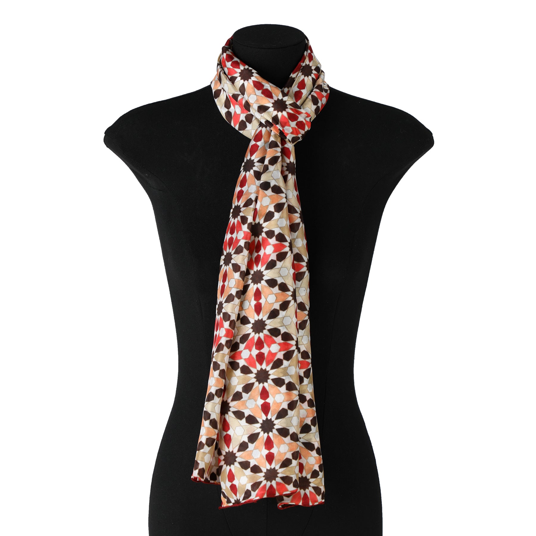 The Islamic Mosaic Tile Silk Scarf Suhail V1, made of Habotai silk with red, black, and beige geometric patterns inspired by Islamic mosaic tiles, is draped around the neck of a black mannequin torso on a white background.