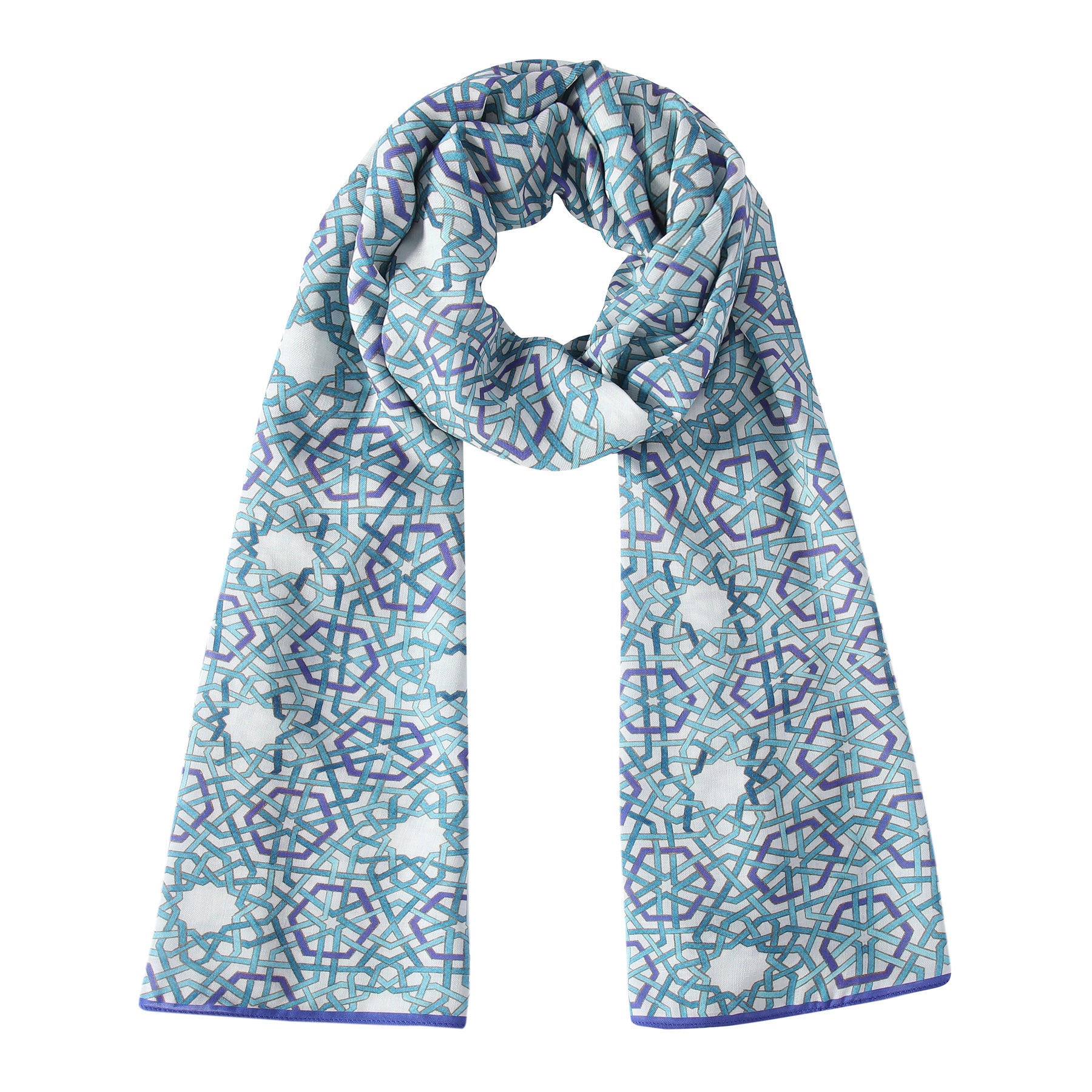 The Modal Scarf with Blue Print features a silky modal fabric and an intricate blue geometric pattern inspired by Islamic art, shown looped on a white background in teal, purple, and white tones.