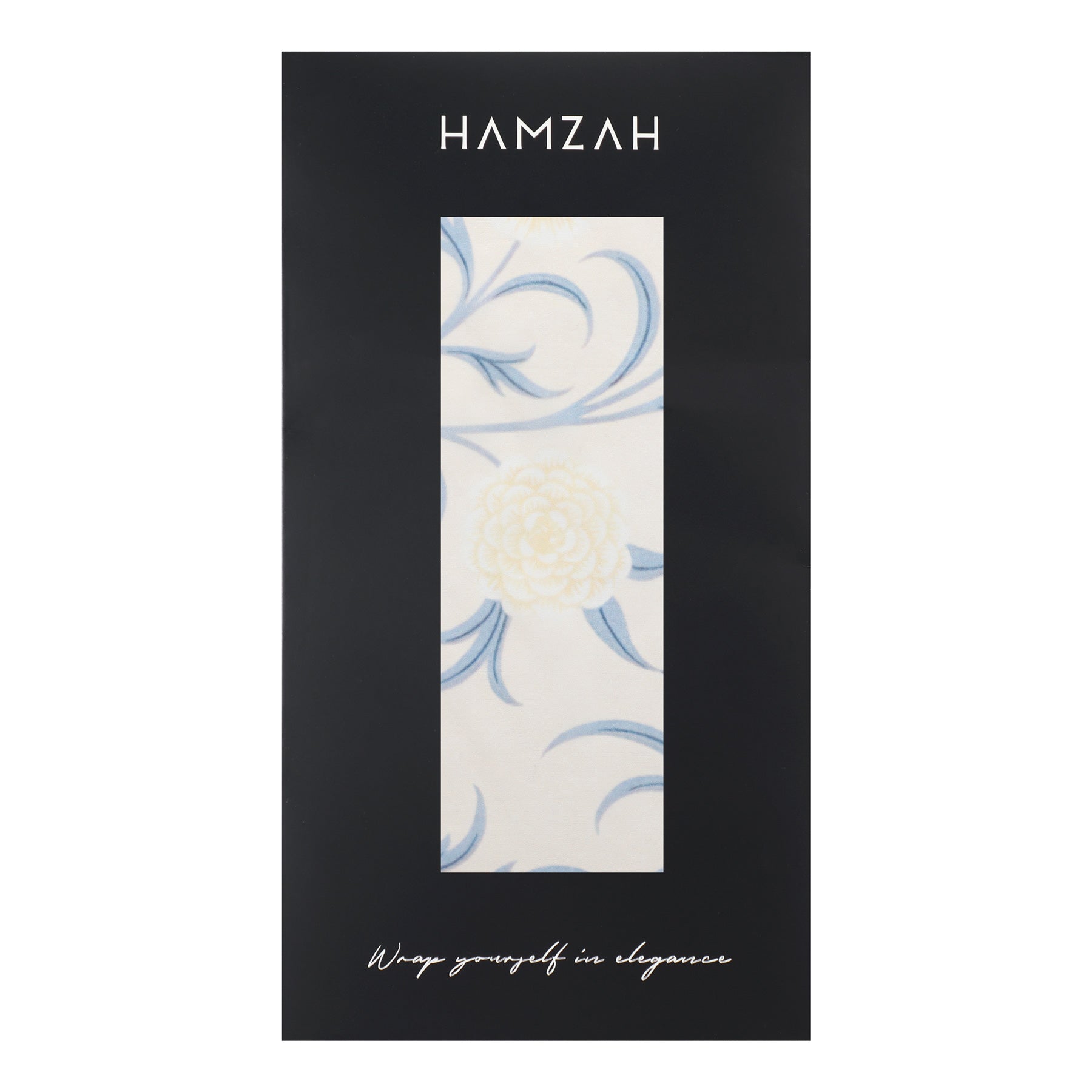A black package with the brand name Hamzah features a window displaying the William Morris Floral Scarf in light color, a white and blue floral patterned fabric. At the bottom, it reads Wrap yourself in elegance, suggesting the luxurious feel of Habotai silk.