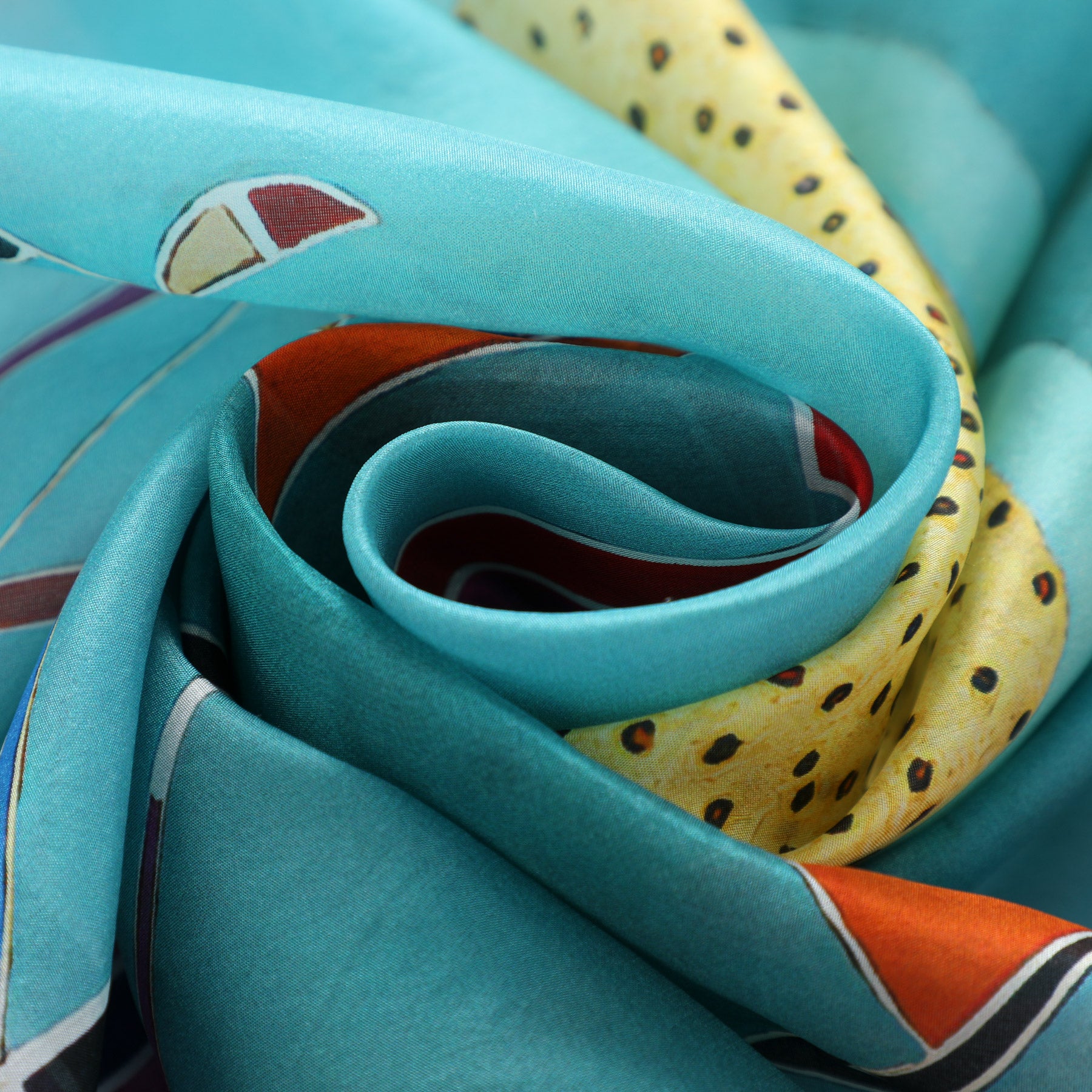 The Kandinsky Scarf - Intime Message by Hamzah, crafted from silky habotai silk, displays abstract patterns with turquoise swirls, yellow with black dots, and touches of red and orange. Elegantly folded, it offers a textured and vibrant allure.