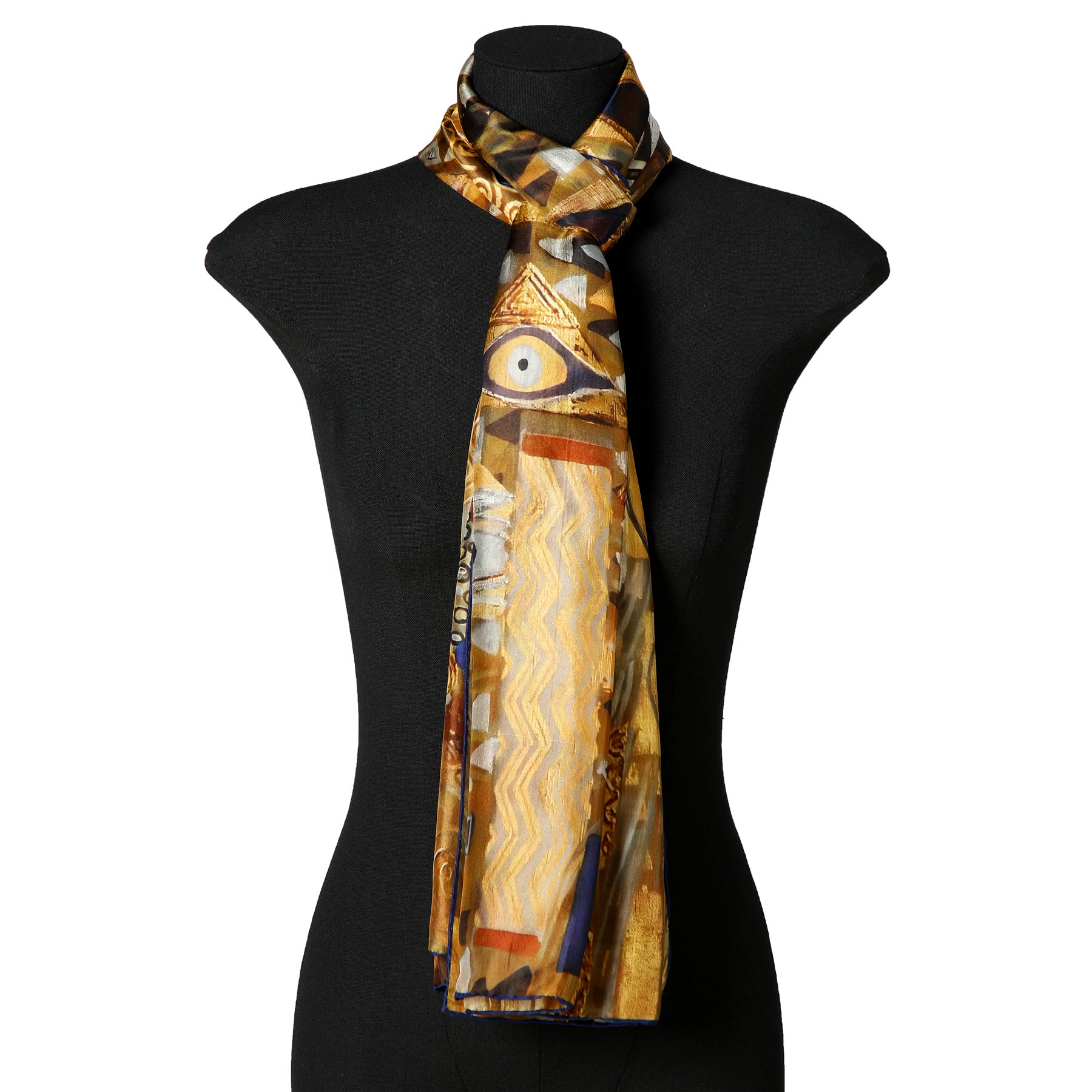 A black mannequin displays the G. Klimt inspired Silk Scarf—long, multicolored silk with abstract geometric patterns in gold, yellow, blue, and brown, inspired by Klimt's Water Serpents, draped loosely around the neck.