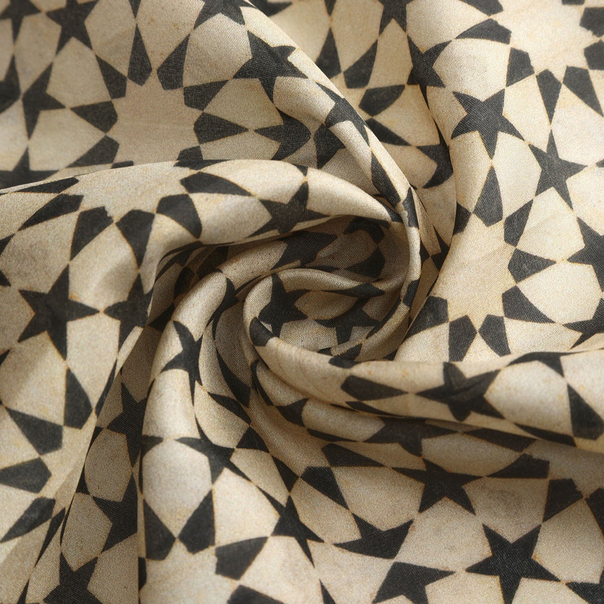 Folded corner of the Black and Cream Silk Square Scarf Nujum, showing the border