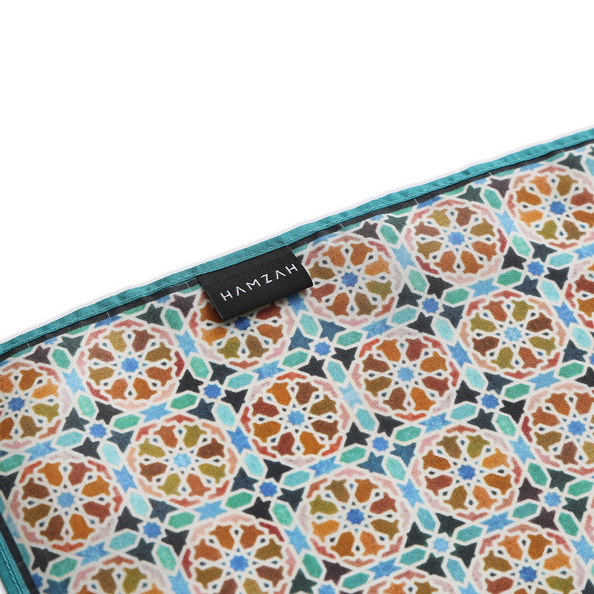 Corner of the Orange Silk Square Scarf Wallada with the Hamzah woven label