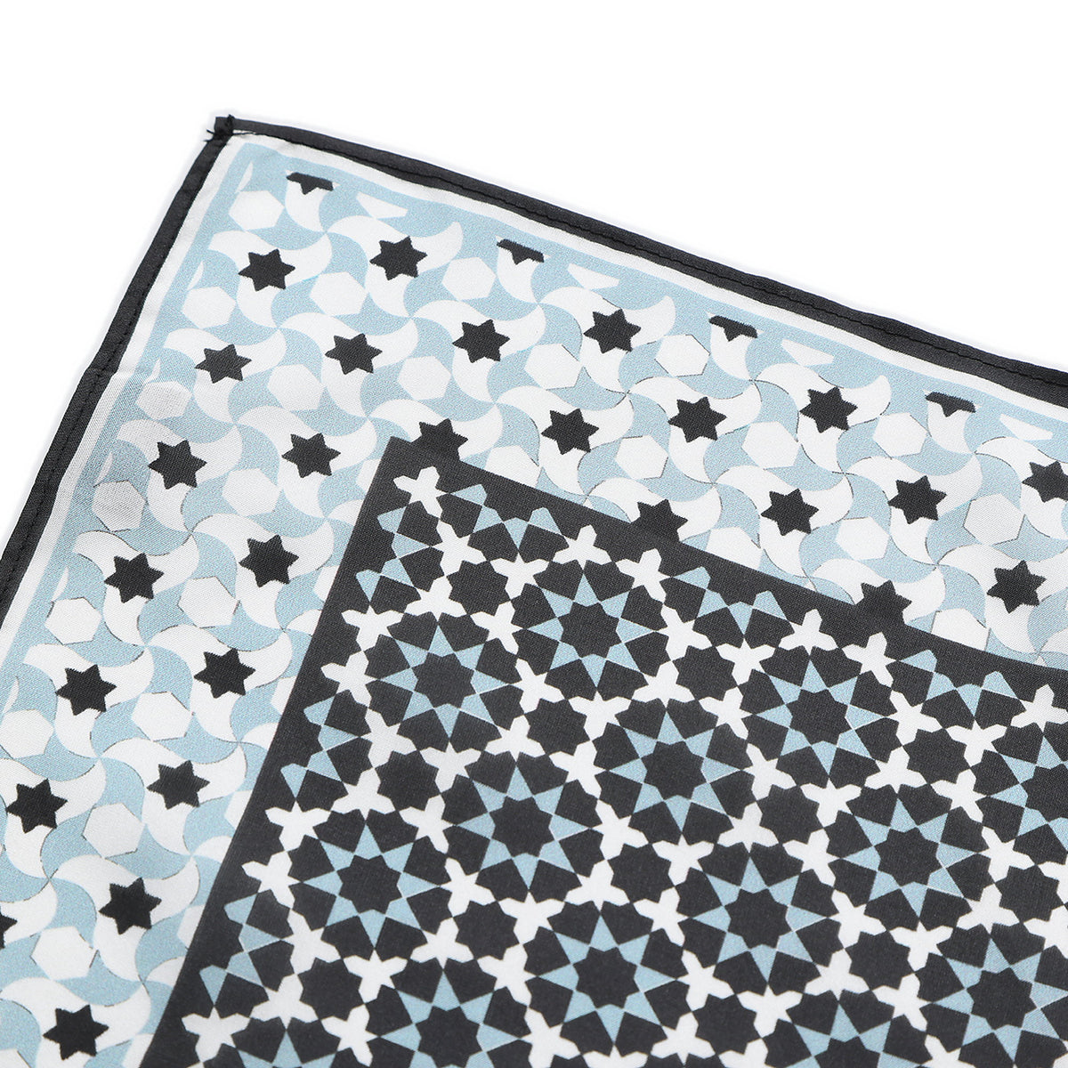 Corner of the Black and Grey Silk Square Scarf Zoraida with the Hamzah woven label