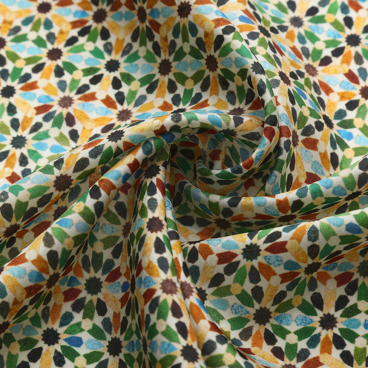 Close-up of the Naima silk print: the multicolour eight-pointed stars on cream