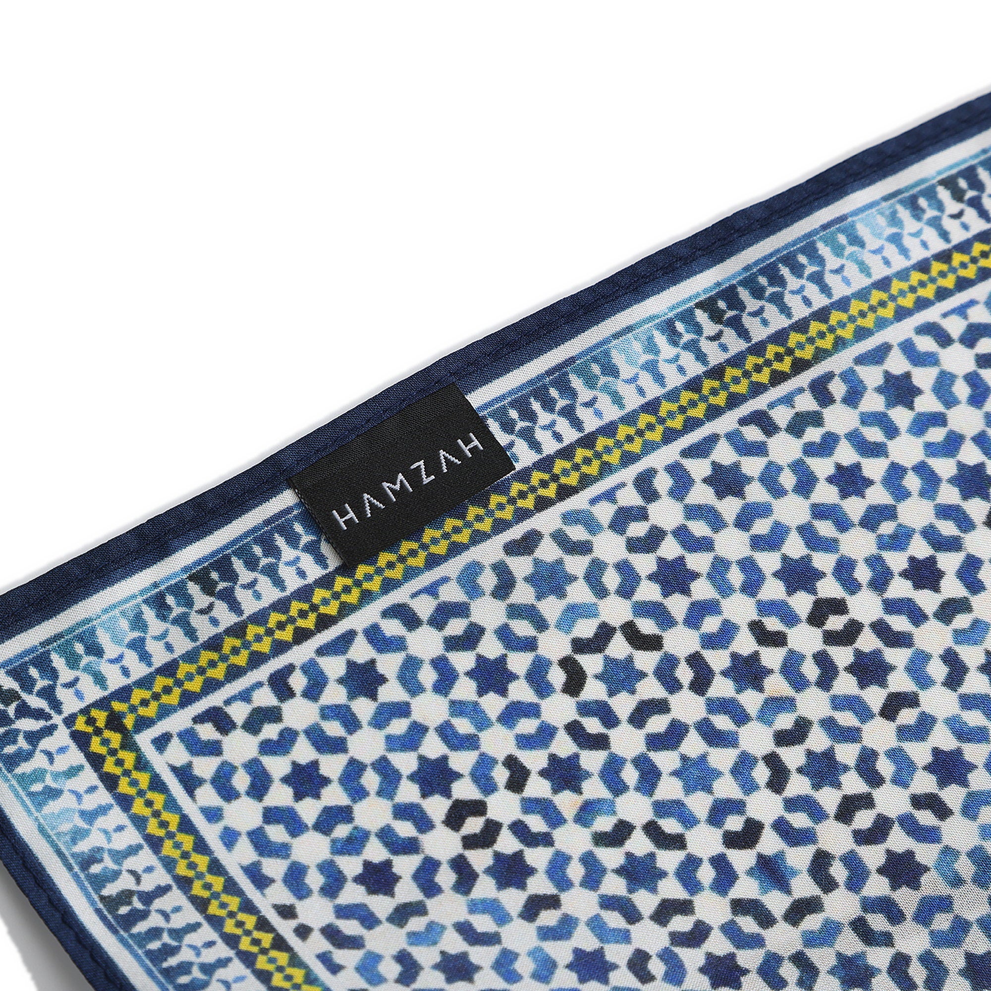 Corner of the Blue Silk Square Scarf Basma with the Hamzah woven label