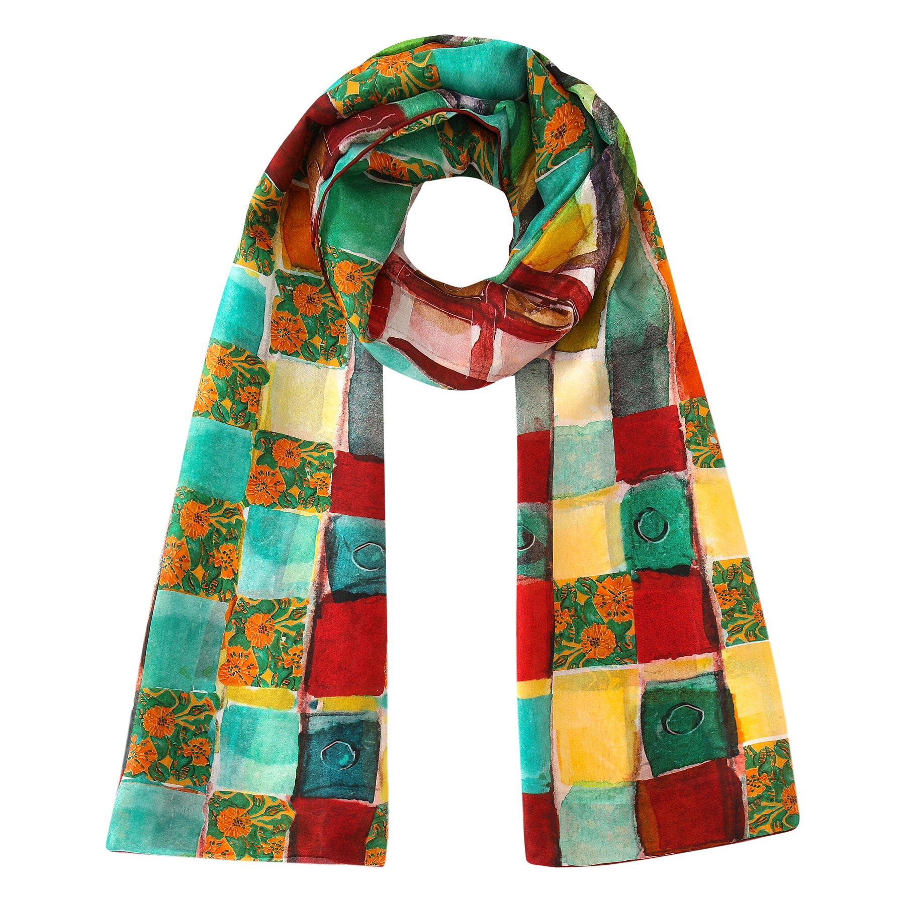 The Gaudí inspired Silk Scarf La Mirada features a vibrant patchwork of red, yellow, green, and turquoise squares with floral accents, shown draped in a loose loop with ends hanging down.