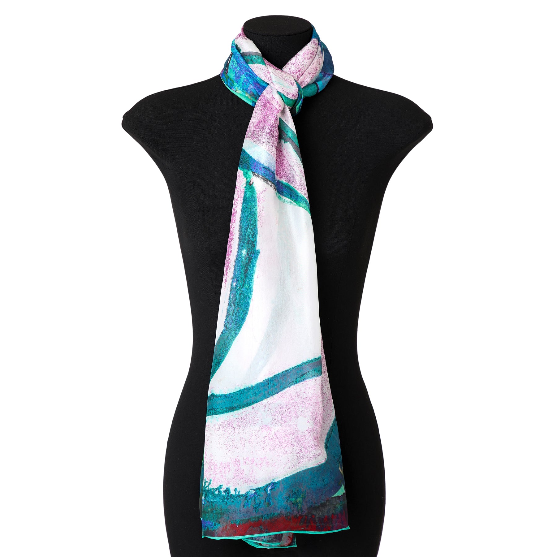 The black mannequin showcases the Silk Shawl for Women Rosas Verdes, featuring long, silky habotai silk with abstract turquoise, green, and pink brushstroke patterns—an ideal Mediterranean-inspired accessory.