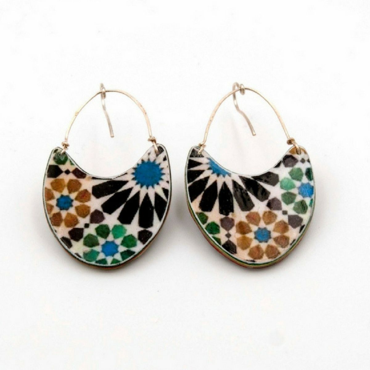 Azul Añils Andalusian Tiles Inspired Earrings Almunecar feature handmade hoop designs with crescent-shaped pendants crafted in Spain. These earrings showcase colorful mosaic patterns in blue, green, black, and brown, inspired by Andalusian tiles for an artistic look.