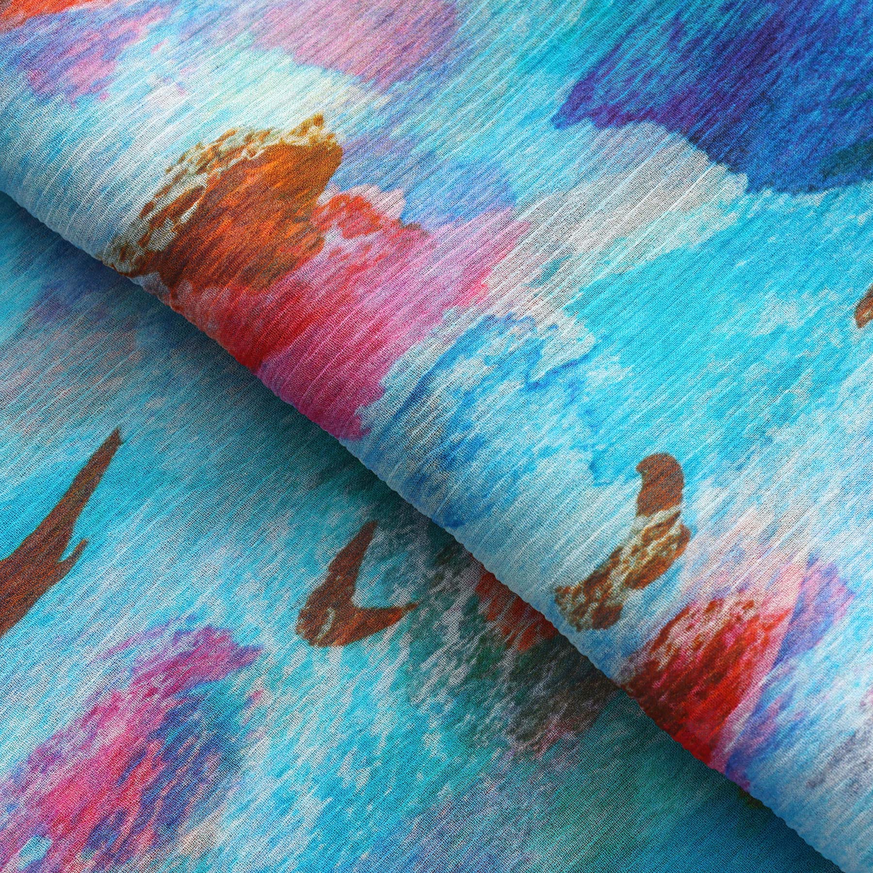 A close-up of the Multicolor Silk Scarf Mar Rojo, featuring watercolor-inspired abstract patterns in bright blue, red, pink, orange, and purple with soft brushstrokes and a slightly textured muslin silk surface—a wearable artwork.