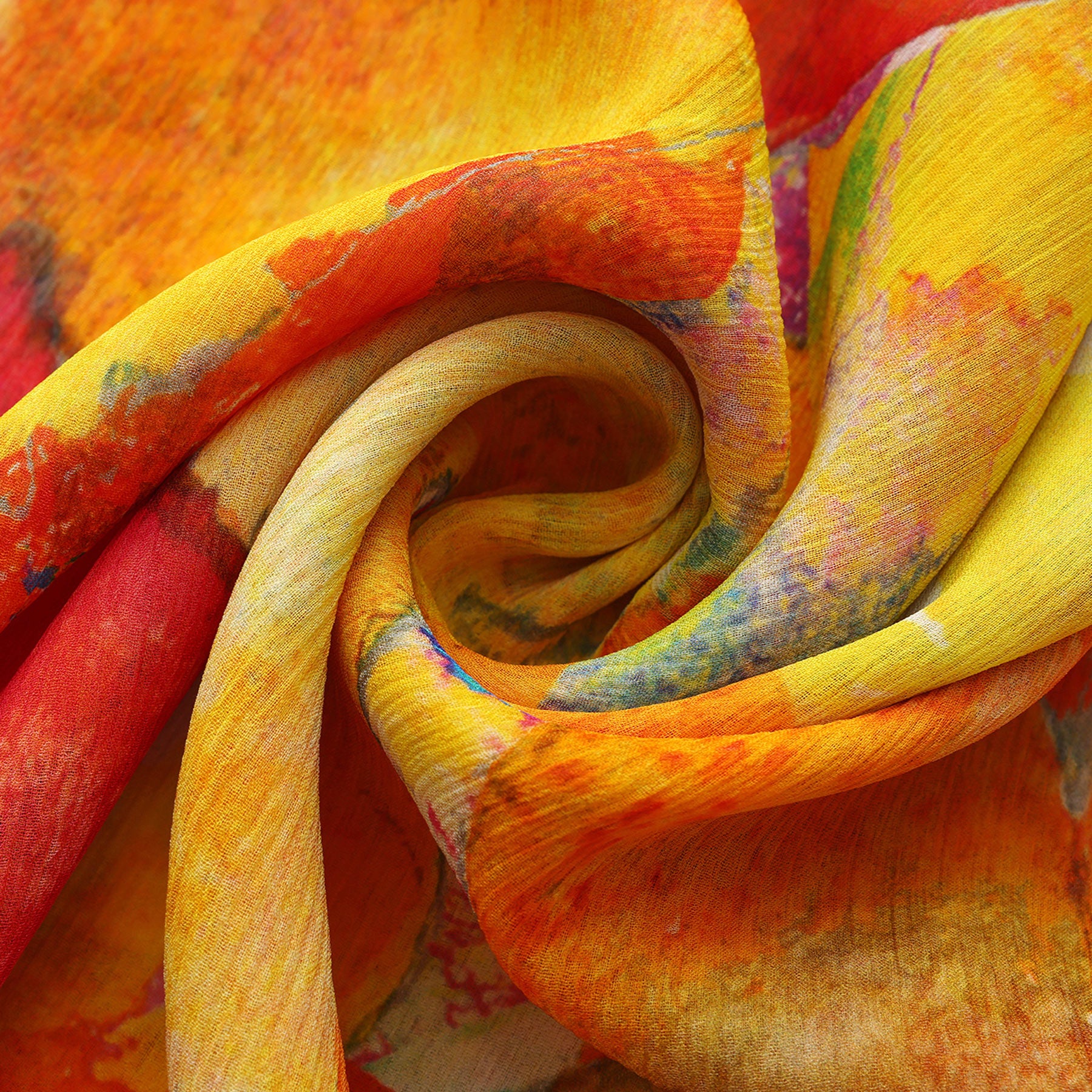 A close-up of the Multicolor Silk Scarf Demeter, featuring soft muslin silk with swirling folds and a vibrant abstract pattern in yellow, orange, red, green, and blue—perfect as wearable artwork.