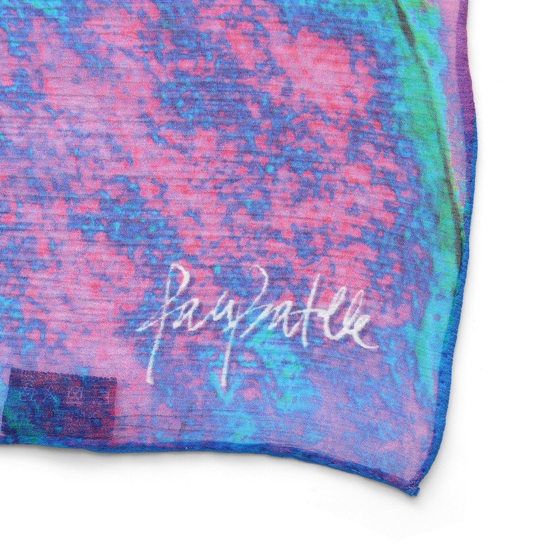Close-up of the Multicolor Silk Scarf Océano Fucsia, featuring a vibrant abstract pattern in blue, pink, and purple