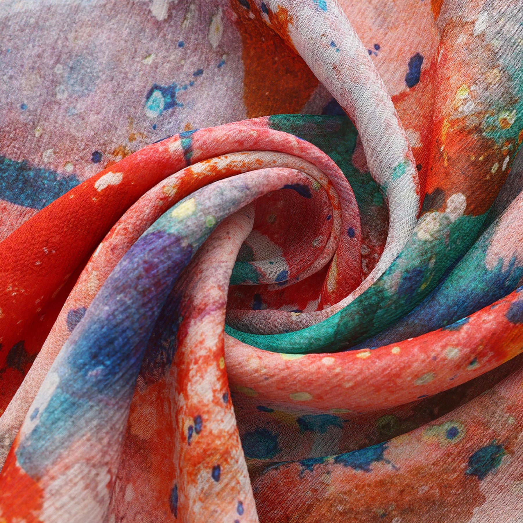 A close-up of the Multicolor Silk Scarf Cangrejos, swirled to showcase vibrant red, blue, green, purple, and white with a watercolor effect—an abstract-patterned muslin silk accessory that’s true wearable art with a textured look.