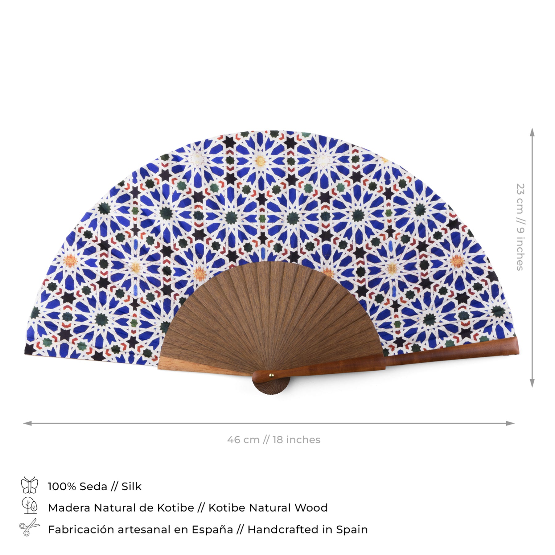 The Blue and White silk fan Zellige features Islamic geometry on natural wood ribs. Handcrafted in Spain from silk and wood, it measures 43.5 cm wide by 23 cm tall.