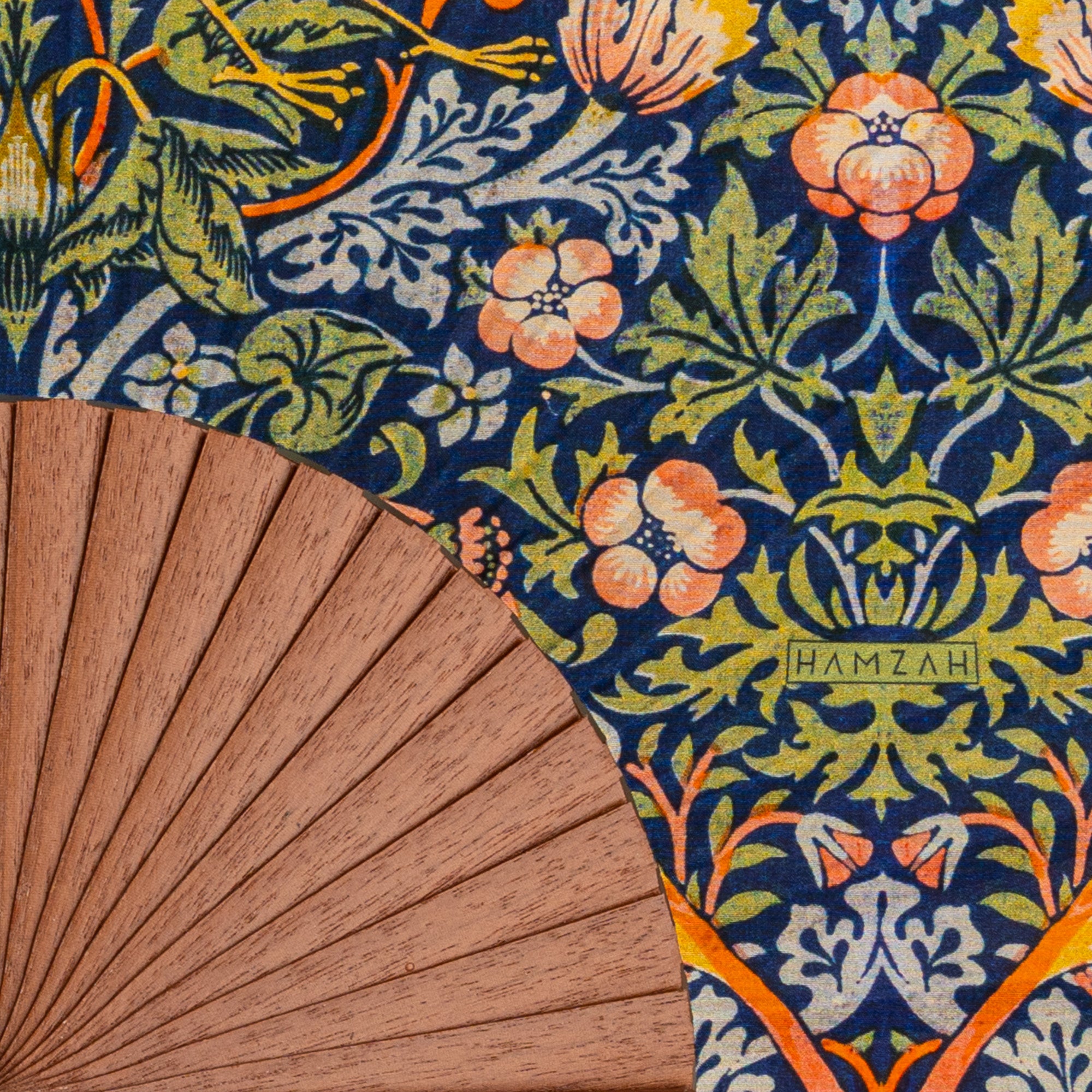 Close-up of the William Morris Print Hand Fan Birds II showing the William Morris Strawberry Thief print on dark silk in detail.