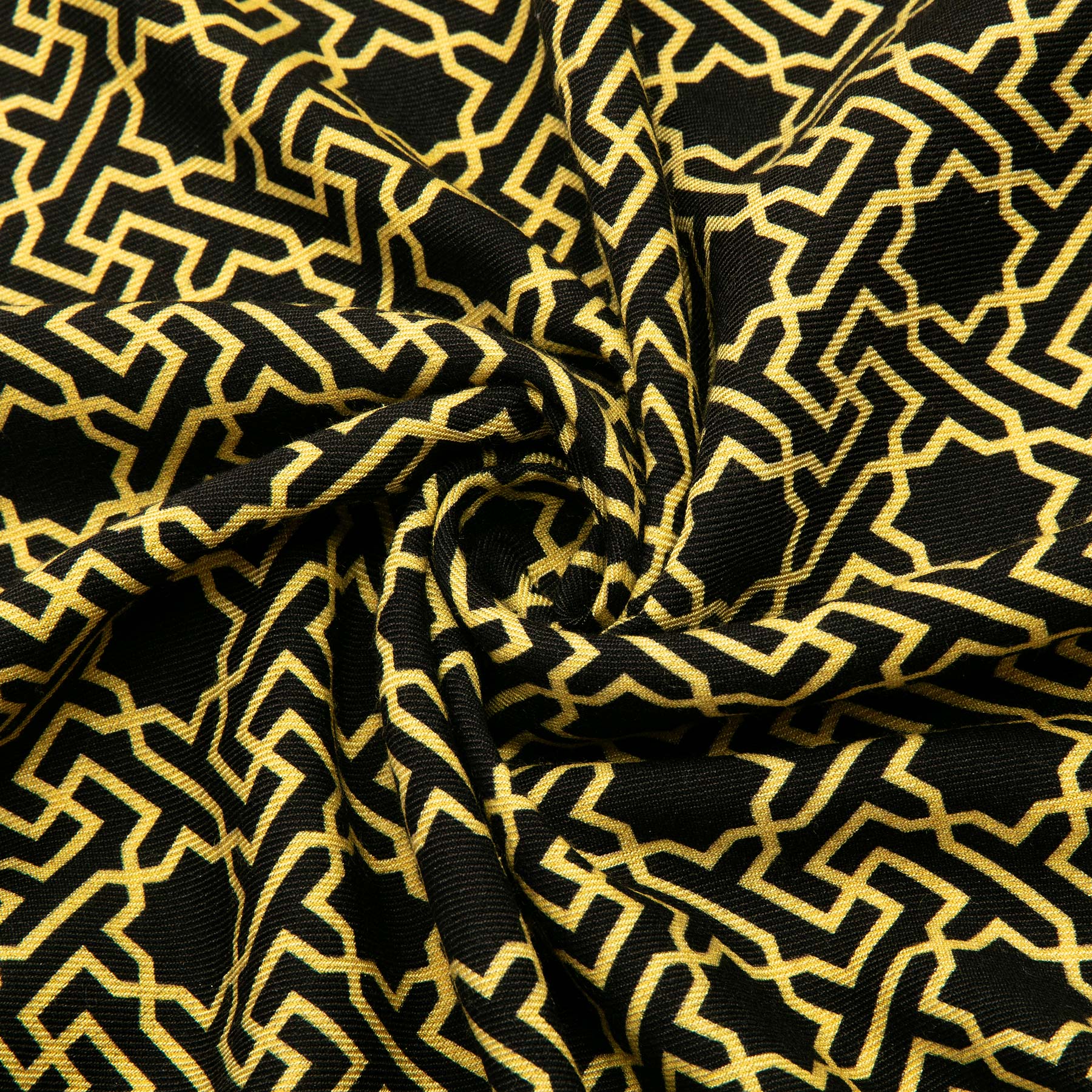 Close-up of the Silk Wool Black and Gold Scarf Rawdah V3, twisted into a spiral to showcase its intricate gold Islamic geometric pattern on black, highlighting the rich texture and striking design.