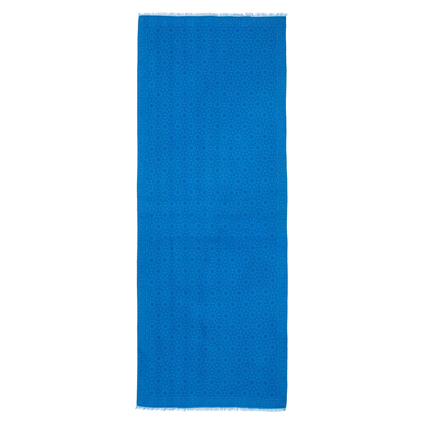 The Silk and Wool Blue Scarf Dalila is a rectangular, bright blue scarf made from a luxurious silk-wool blend, featuring subtle dot patterns and short fringe on the ends, shown laid flat on a white background.