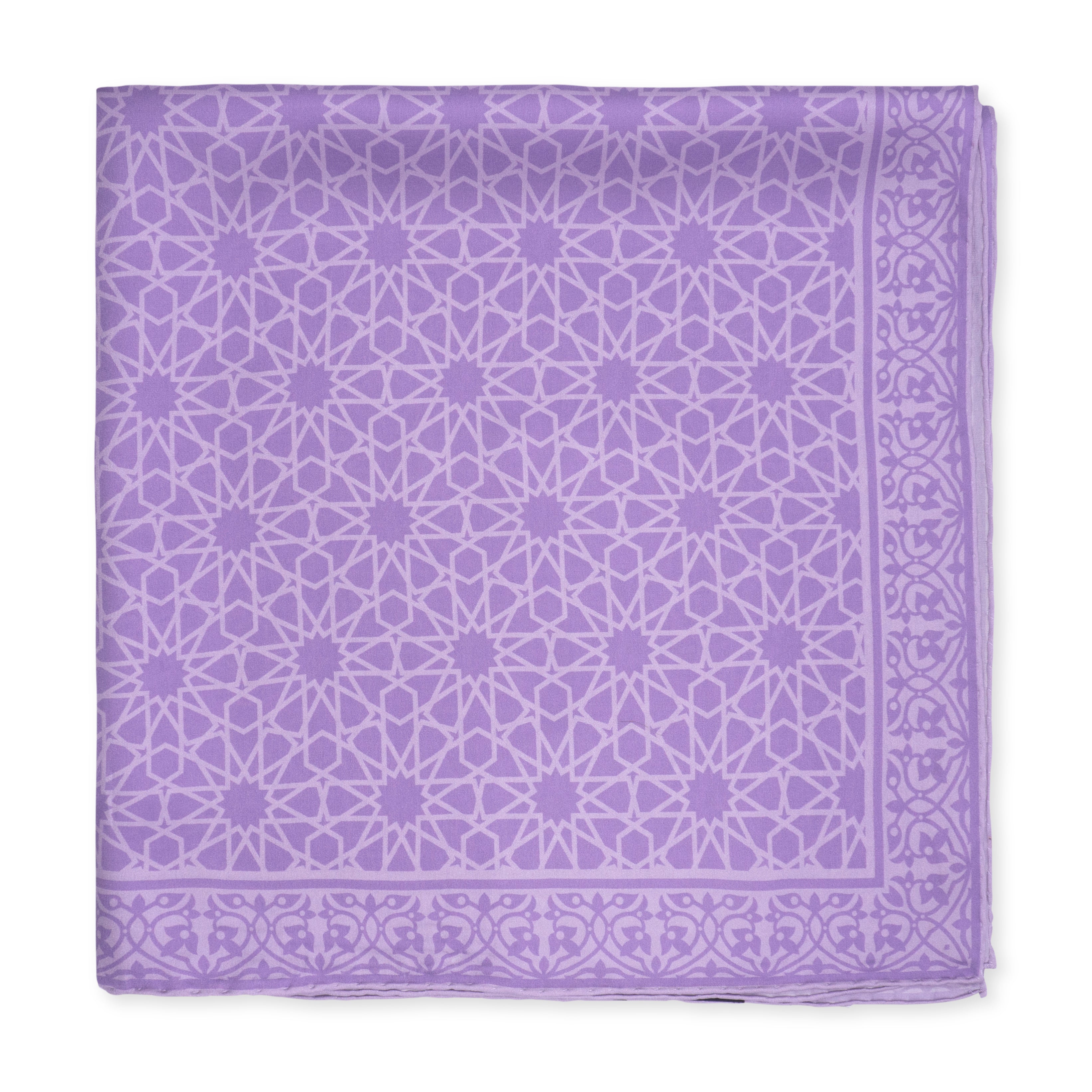 The Purple Silk Square Scarf Dalila is a folded lavender silk scarf with an intricate white geometric star and floral pattern, a matching decorative border, and luxurious finished edges.